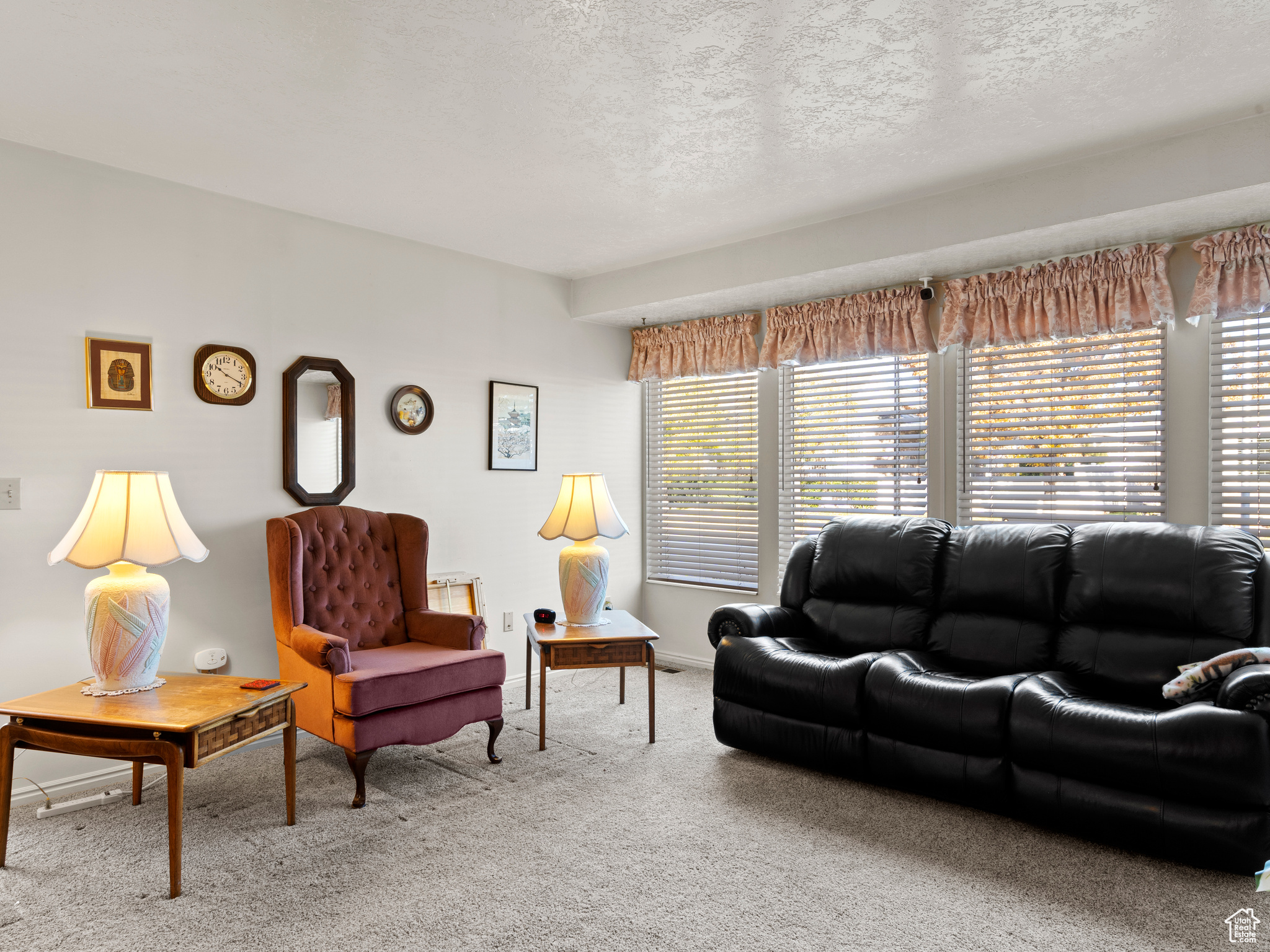 Carpeted living room featuring a textured ceiling