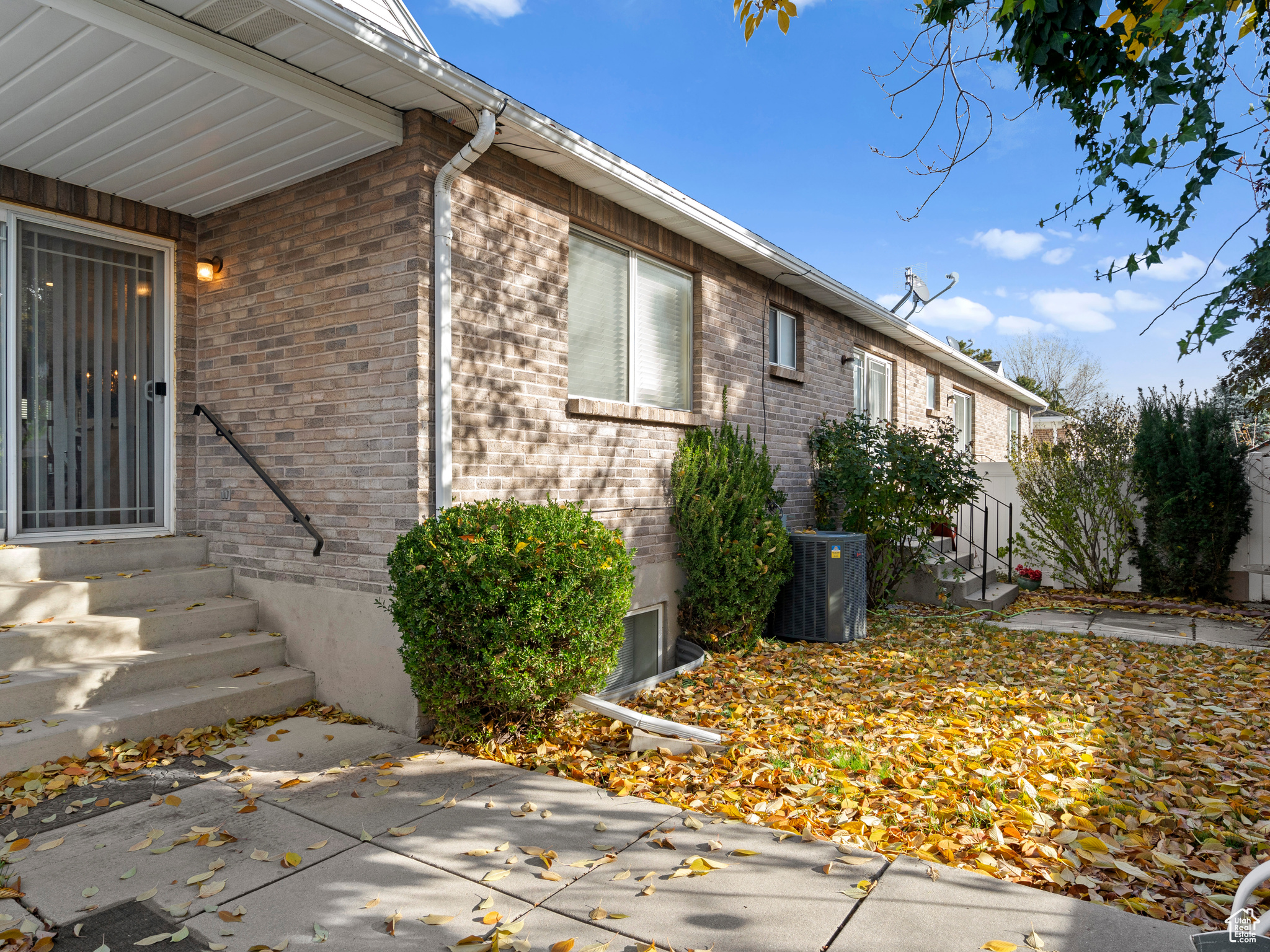 View of property exterior featuring a patio area and central AC unit