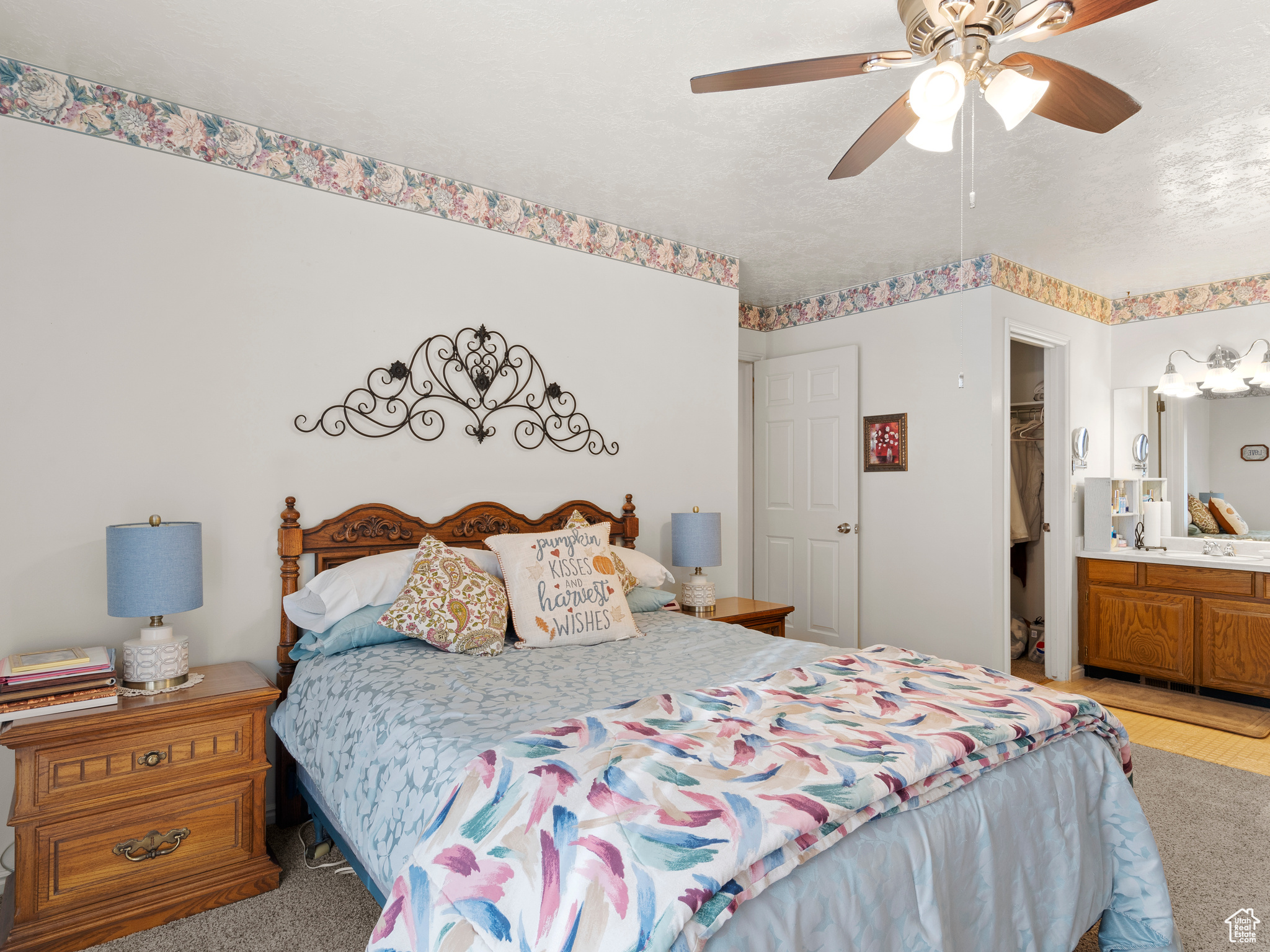 Carpeted bedroom with connected bathroom, a closet, and ceiling fan