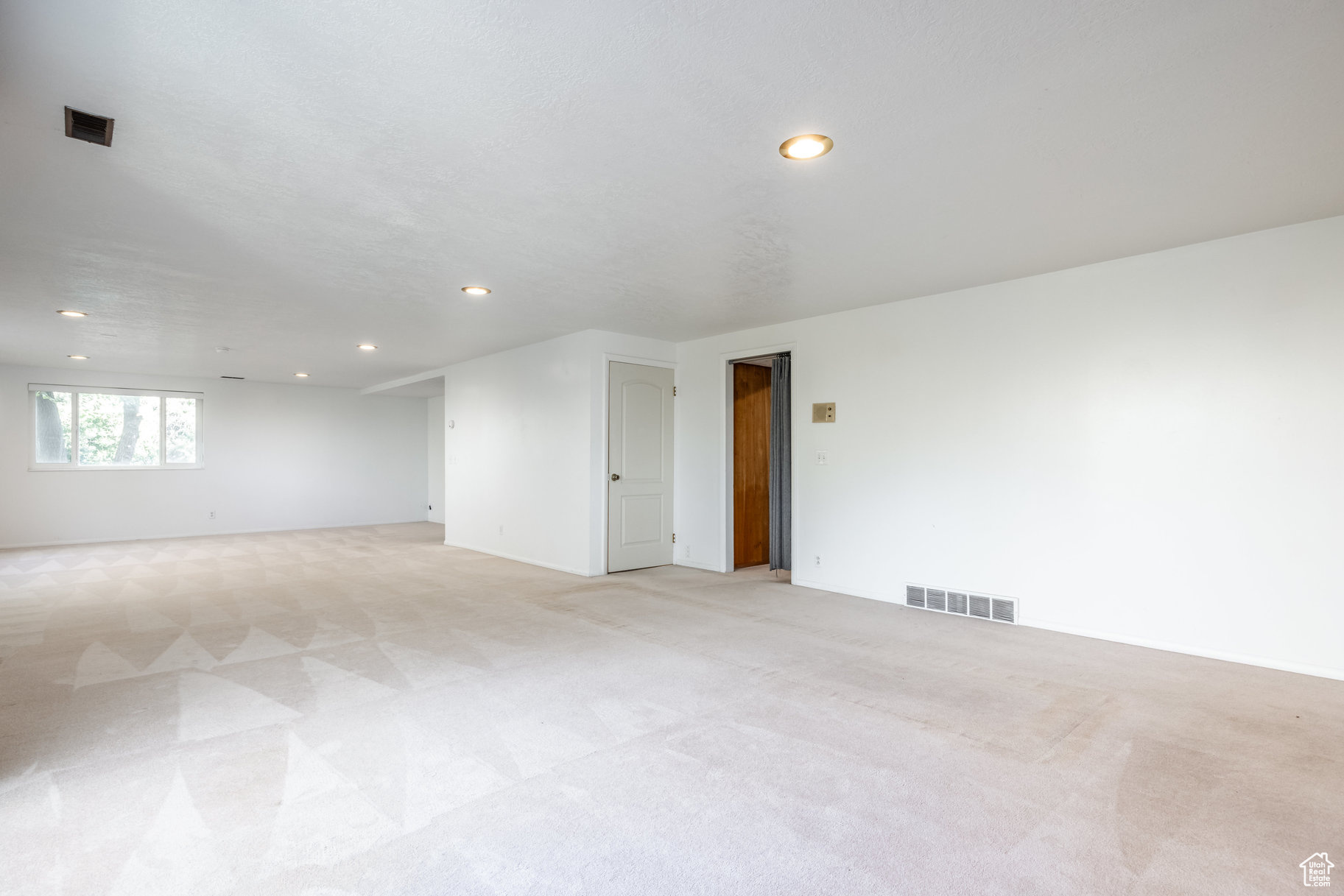 Unfurnished room with light colored carpet