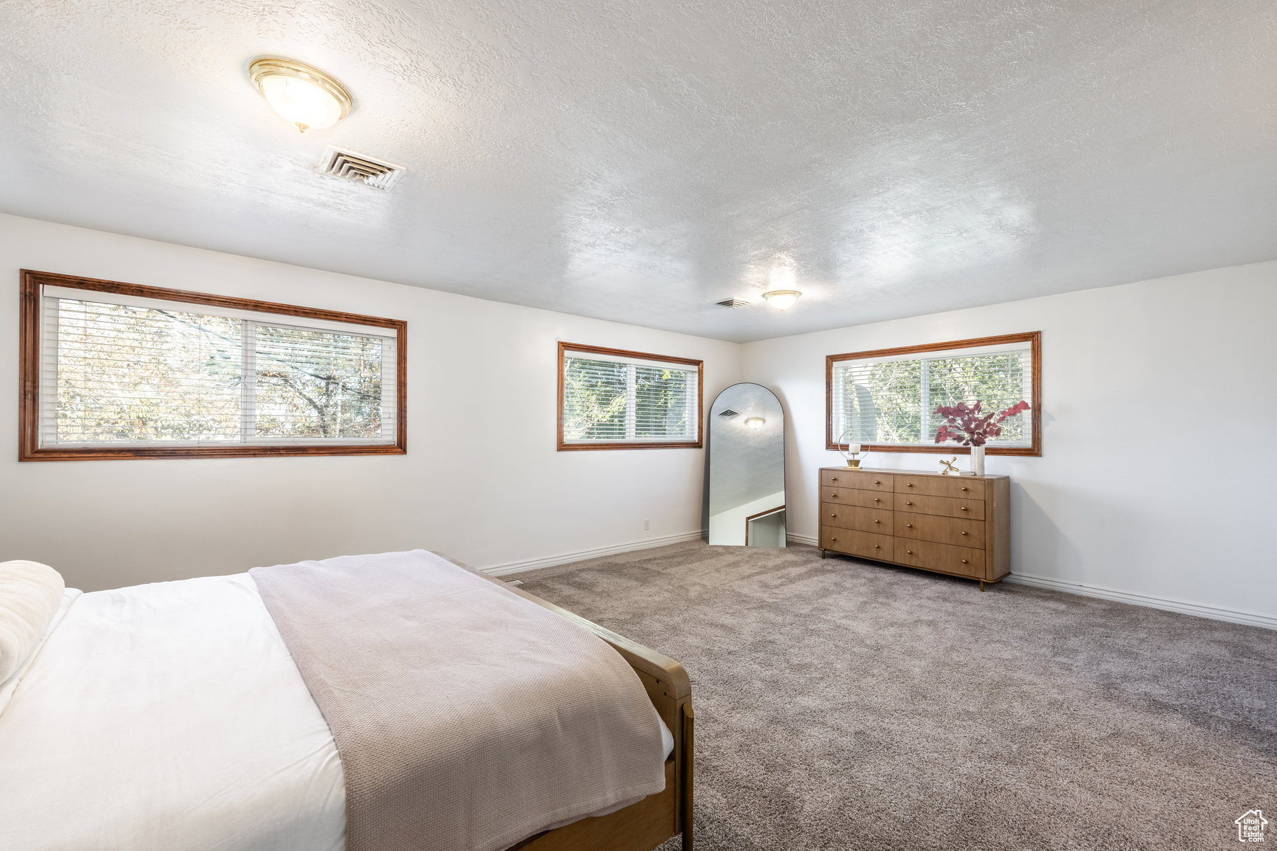 Bedroom featuring carpet floors and a textured ceiling