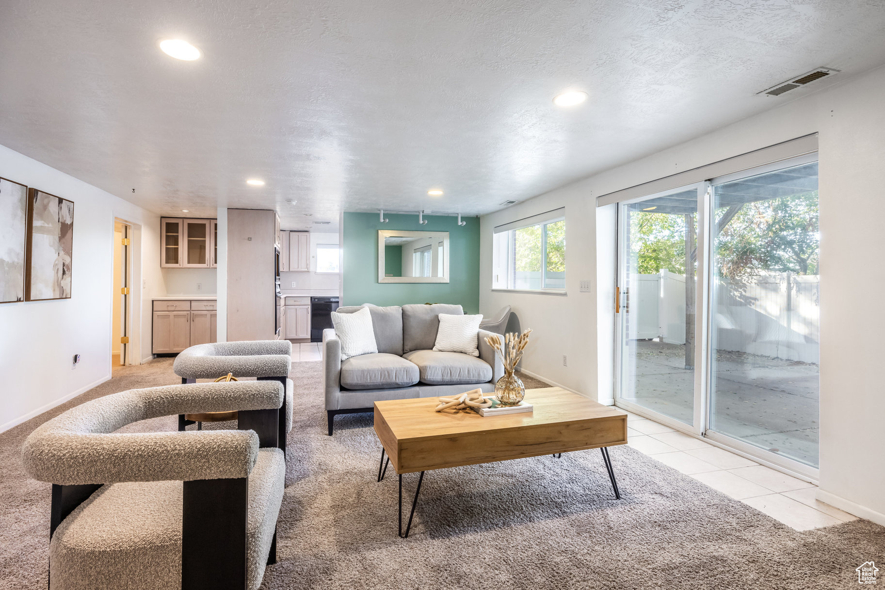 Carpeted living room featuring a textured ceiling