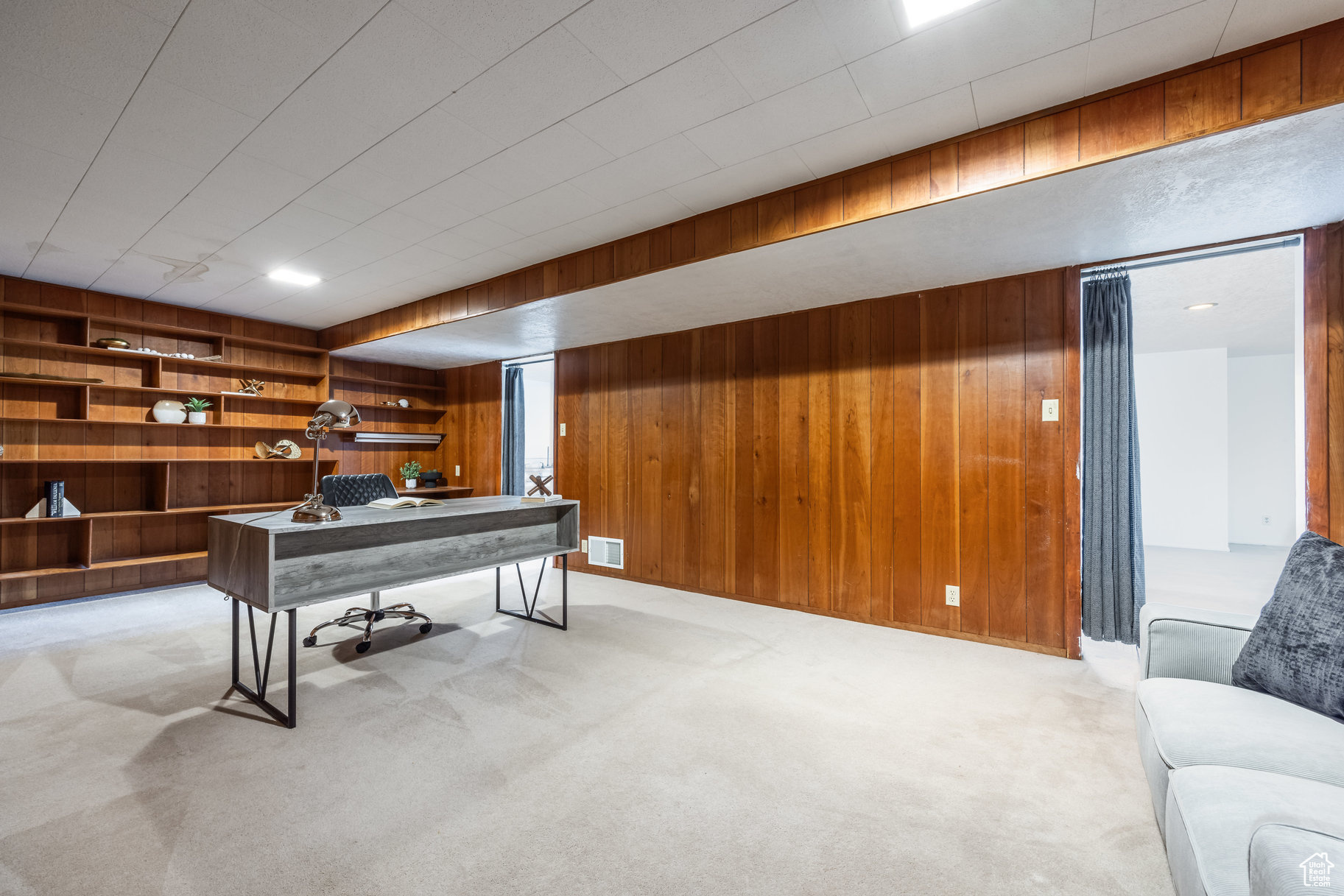 Rec room with wood walls and light carpet