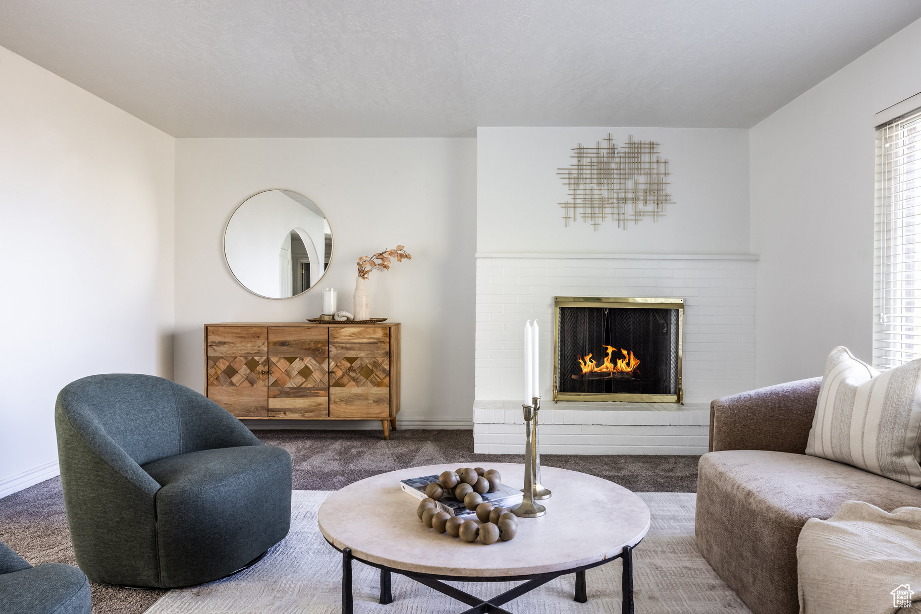 Living room featuring dark carpet and a fireplace