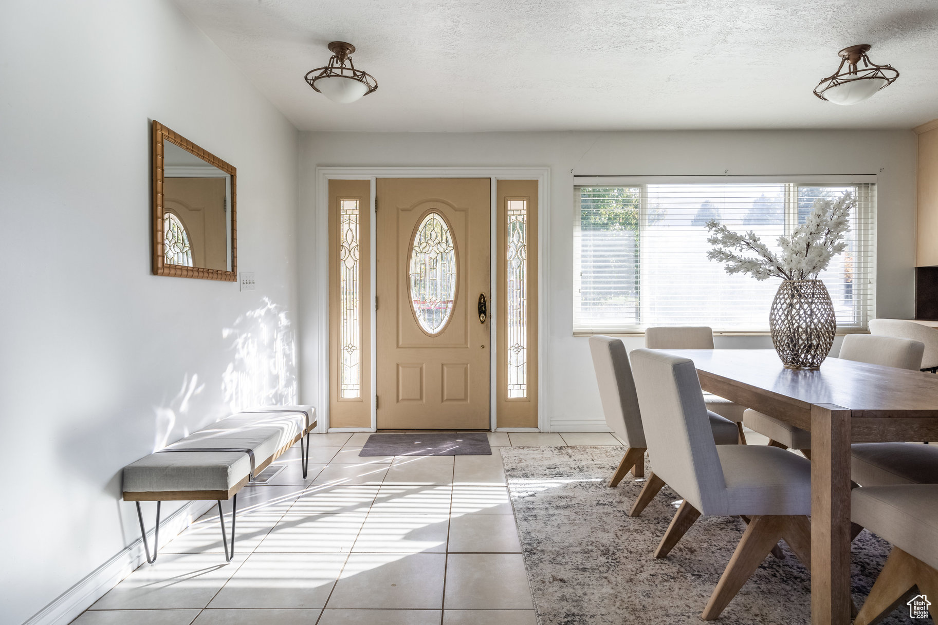 Tiled foyer with a textured ceiling