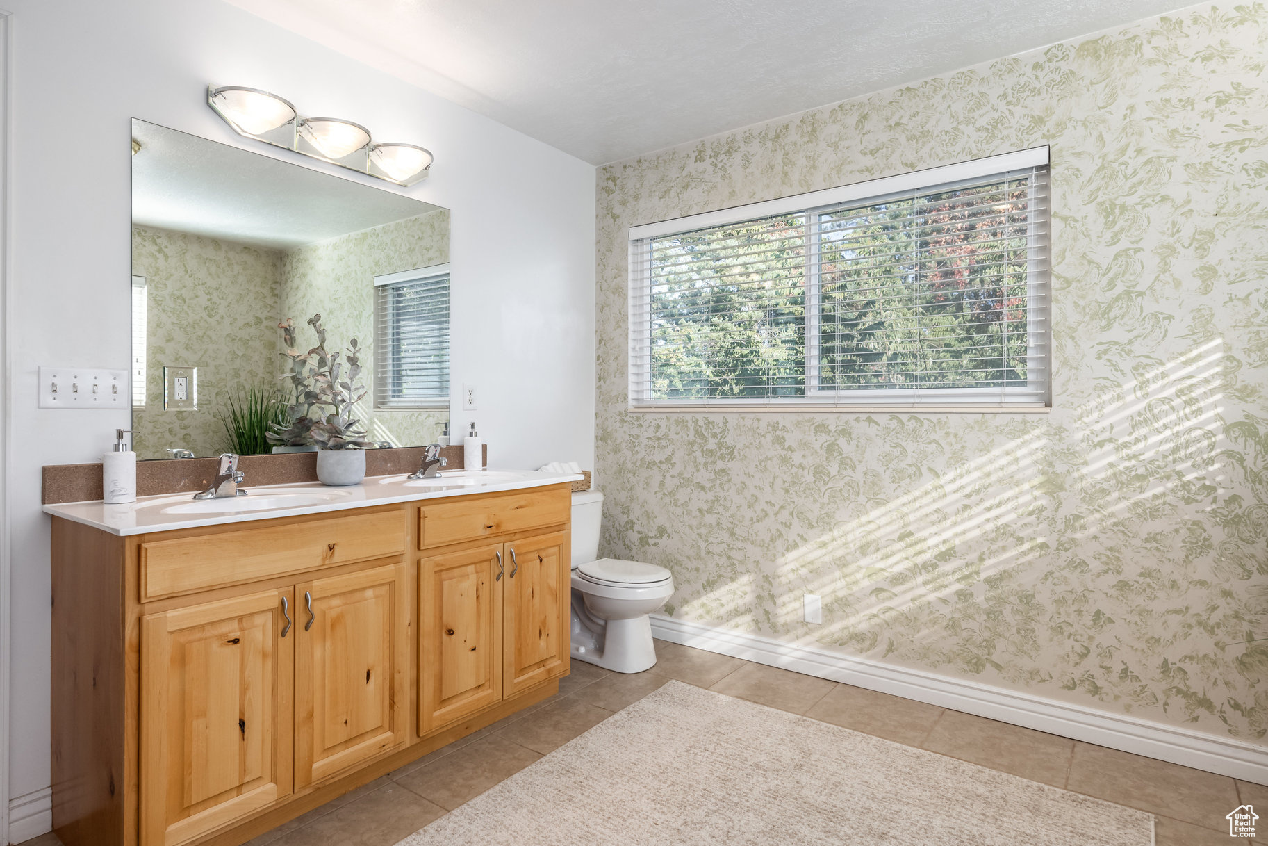 Bathroom with tile patterned flooring, vanity, and toilet