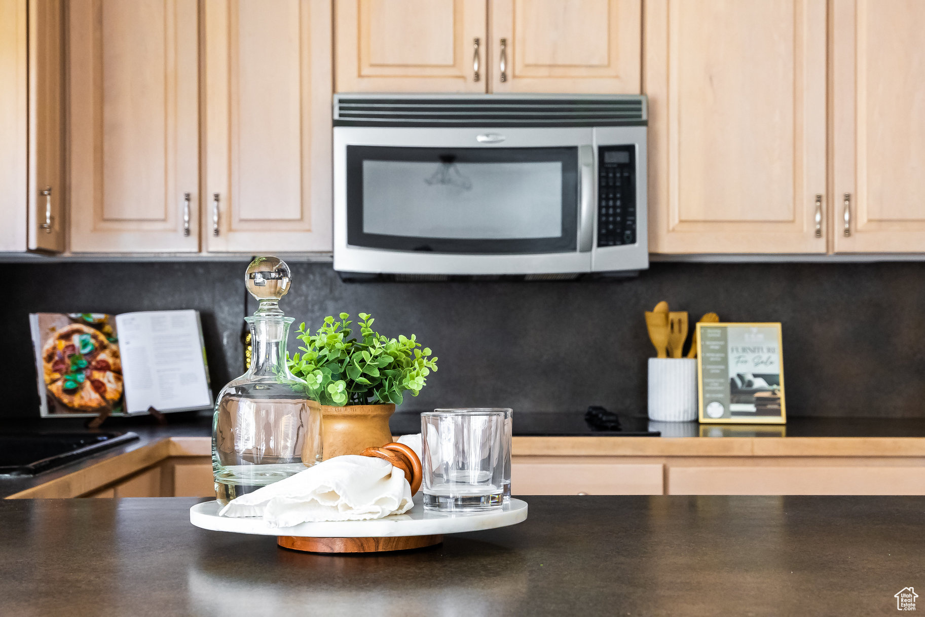 Kitchen featuring backsplash and light brown cabinetry