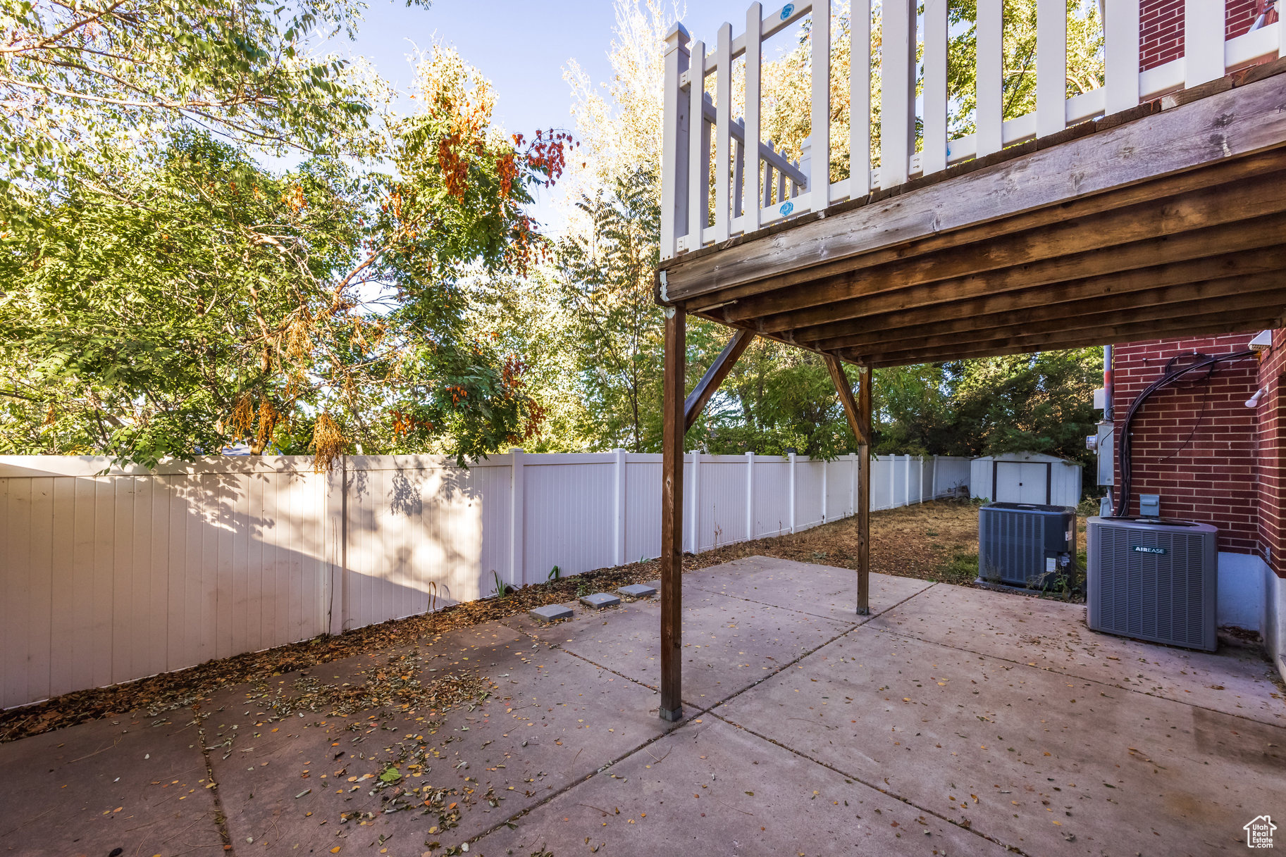 View of patio with central AC unit, a storage shed, and a wooden deck