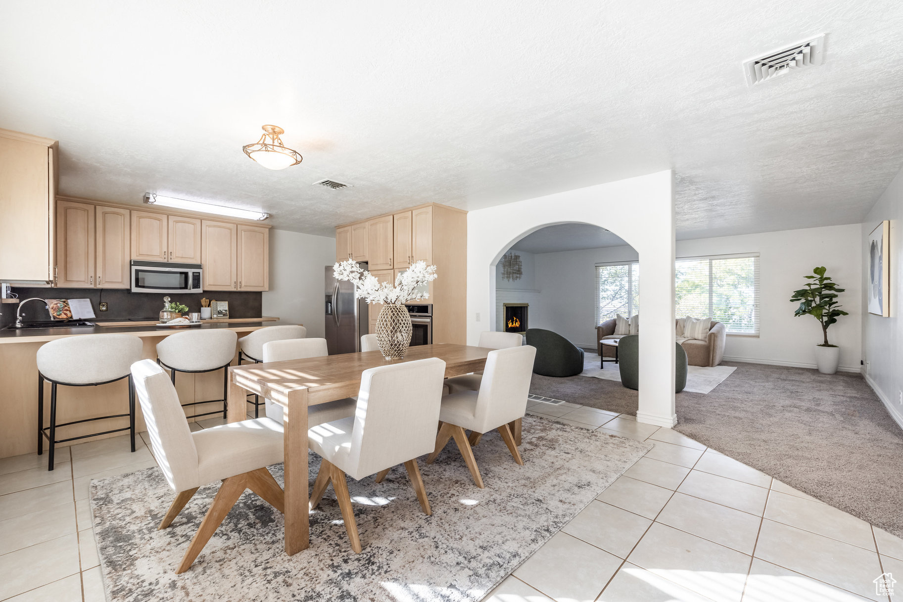 Tiled dining space featuring a textured ceiling