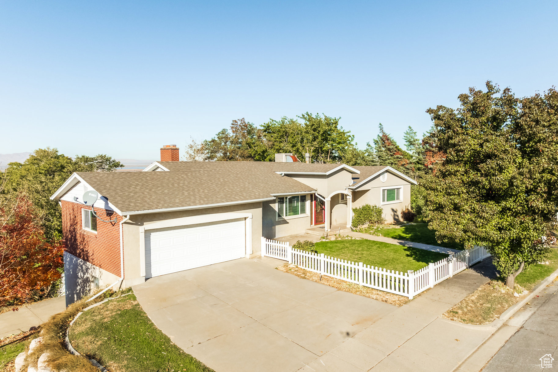 Ranch-style house featuring a garage and a front lawn