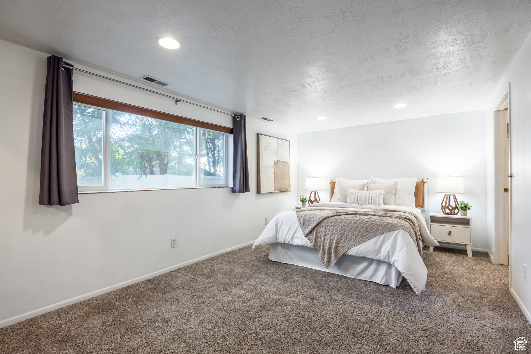 Bedroom with carpet flooring and a textured ceiling