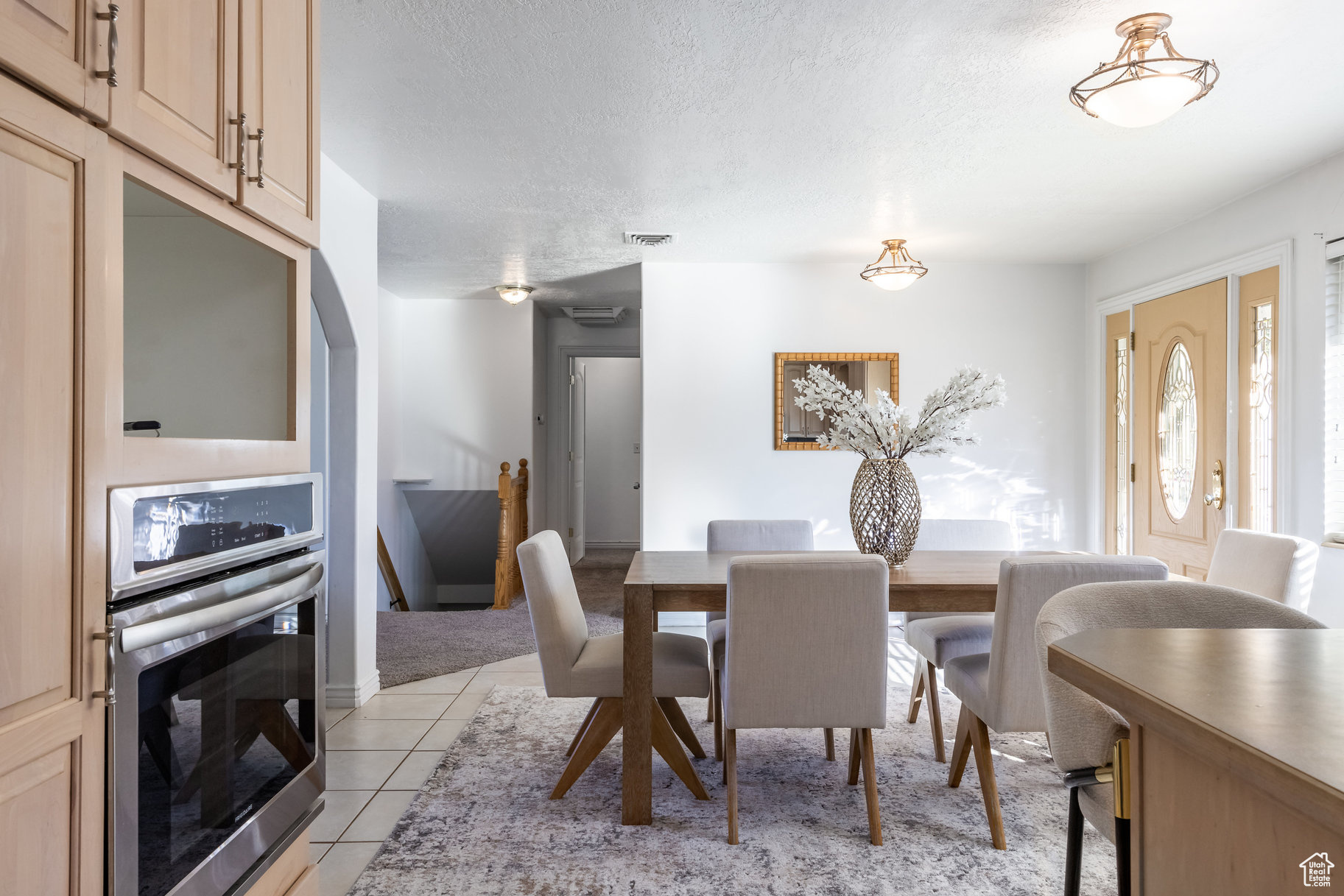 Tiled dining space featuring a textured ceiling