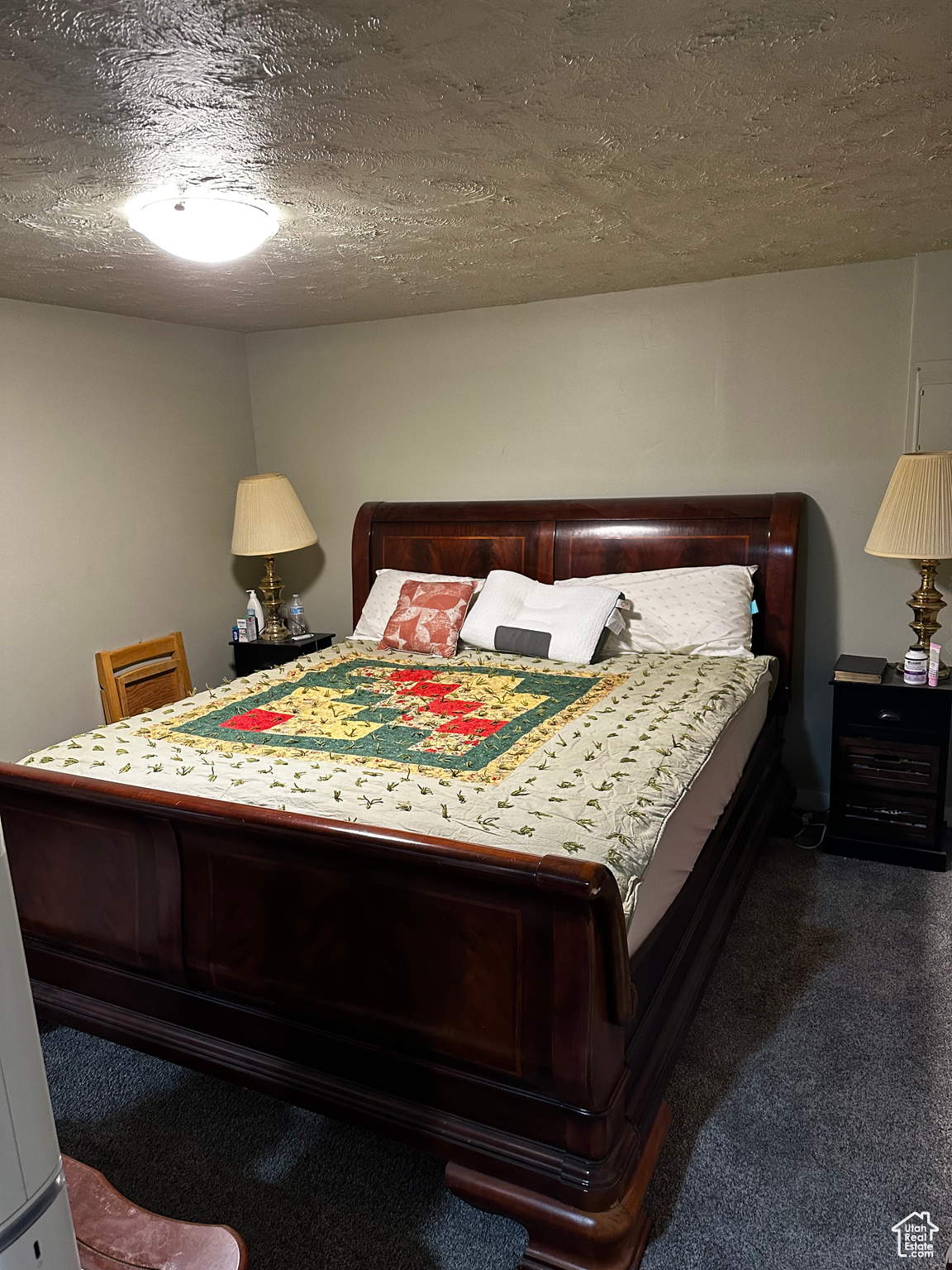 Carpeted bedroom featuring a textured ceiling