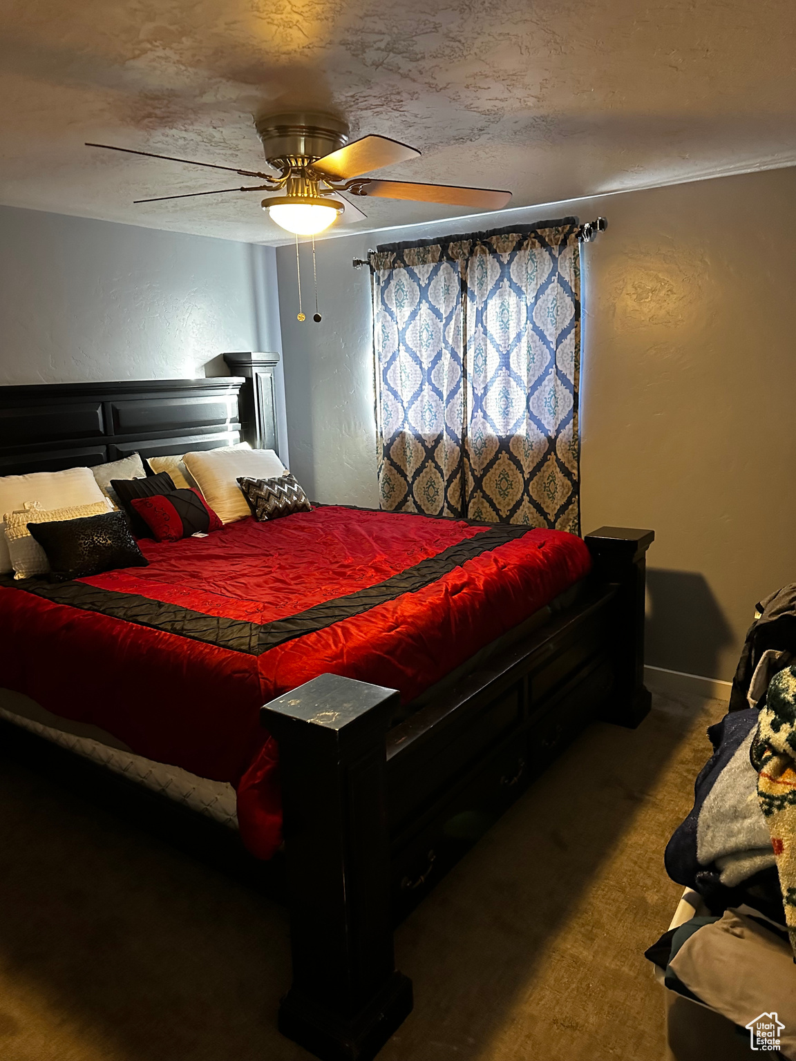 Bedroom featuring a textured ceiling and ceiling fan