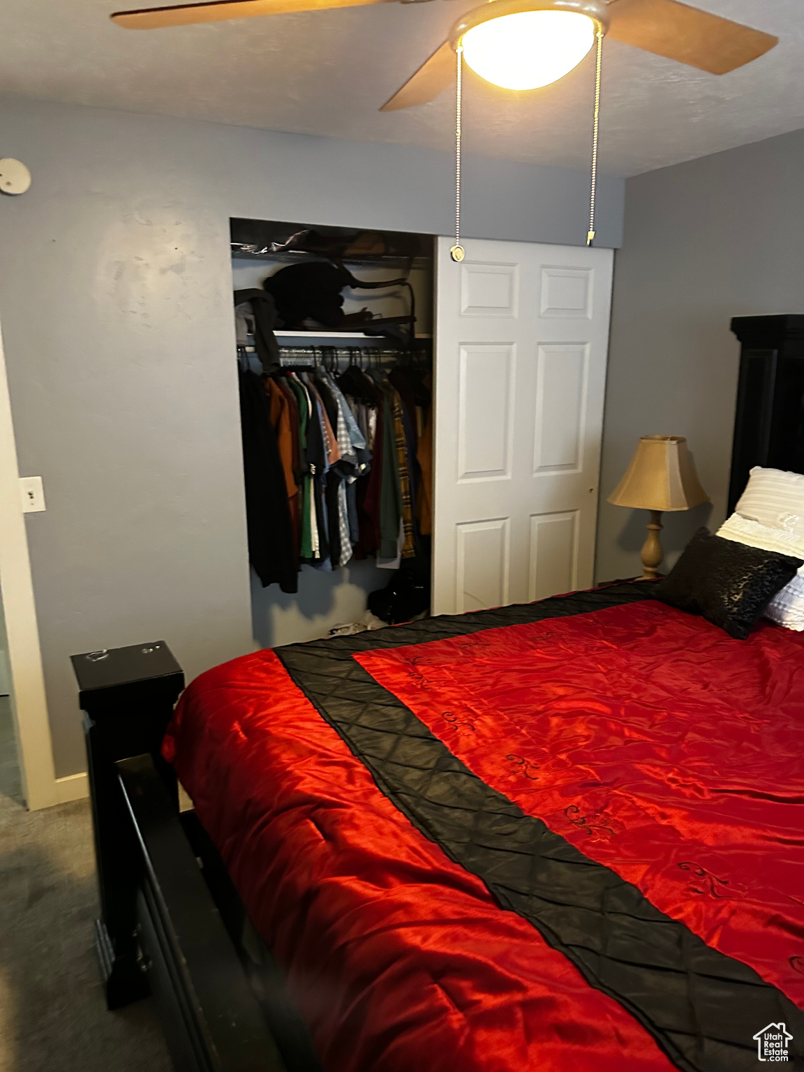 Bedroom featuring carpet flooring, a closet, and ceiling fan