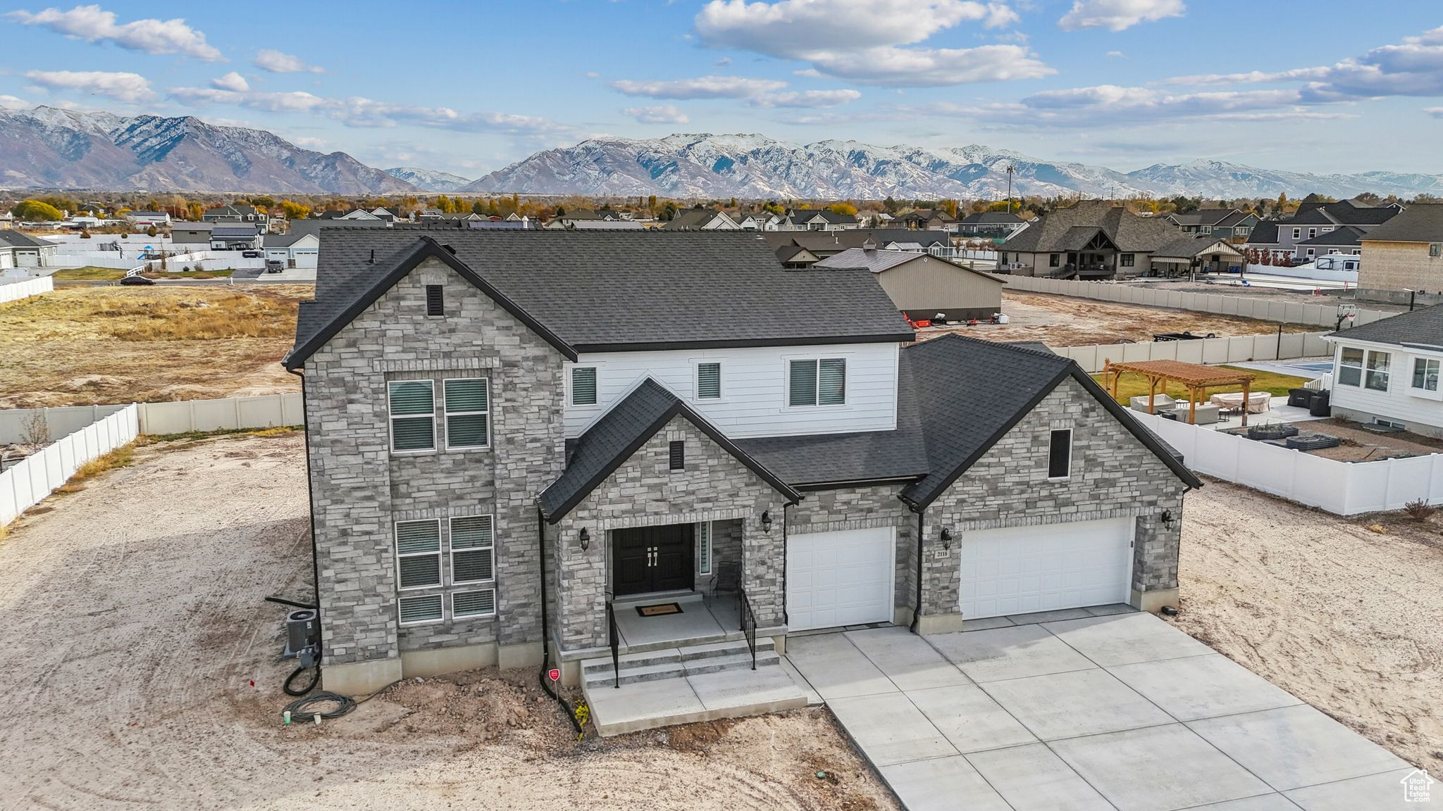 View of front of house with a mountain view and a garage