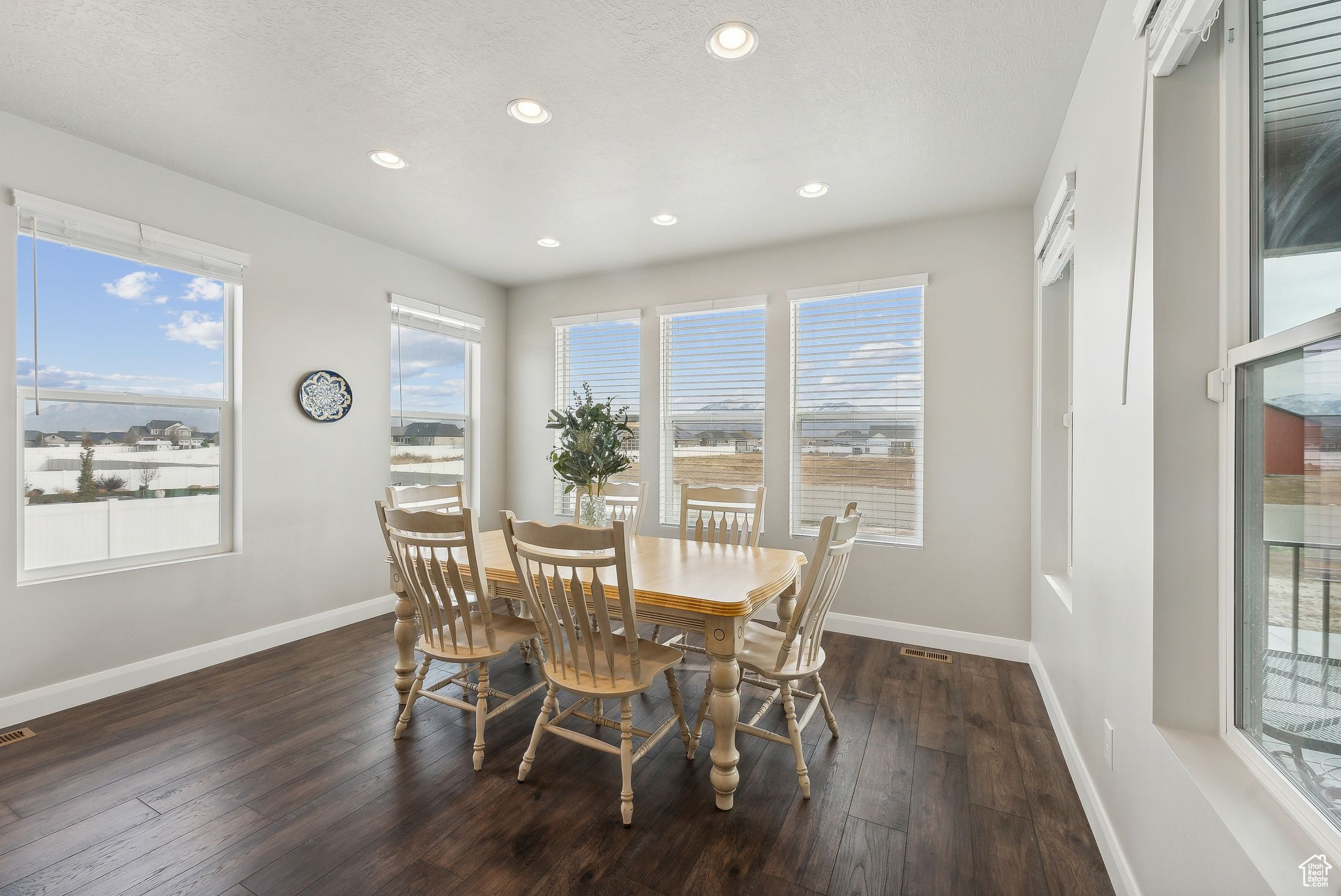 Dining space featuring dark wood-type flooring and a textured ceiling