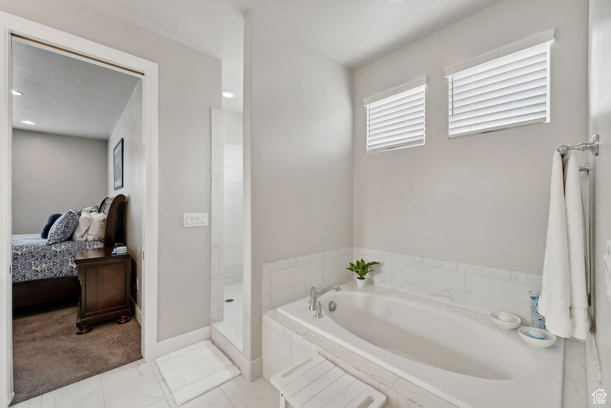 Bathroom featuring shower with separate bathtub