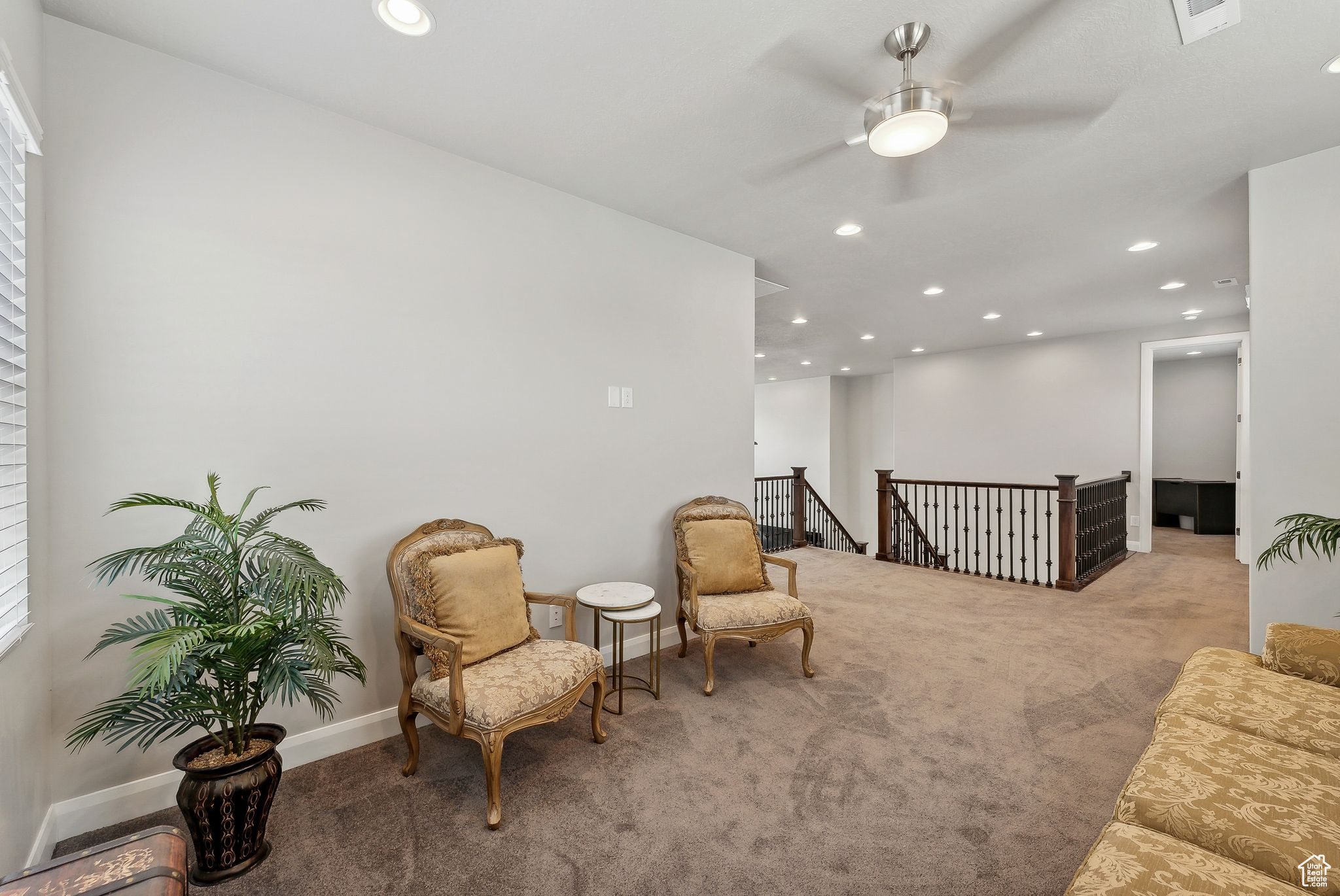 Sitting room featuring light carpet