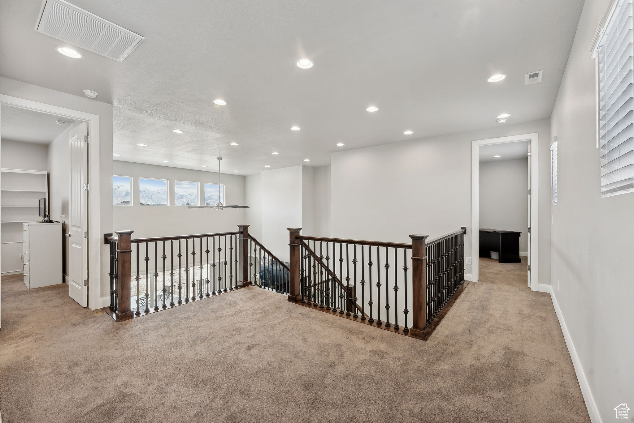 Hallway featuring light carpet