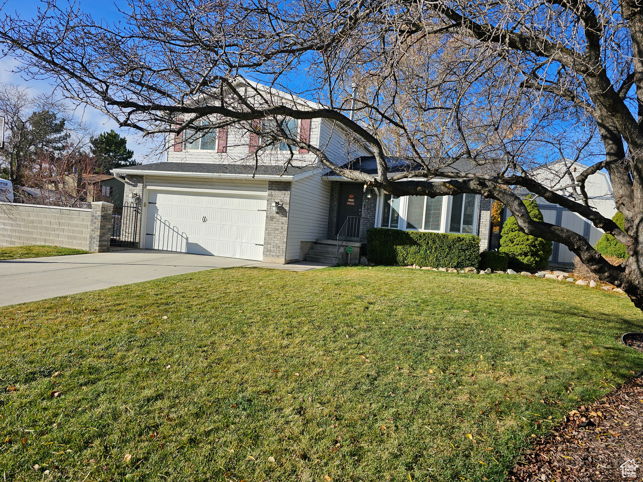 Front of property featuring a garage and a front lawn