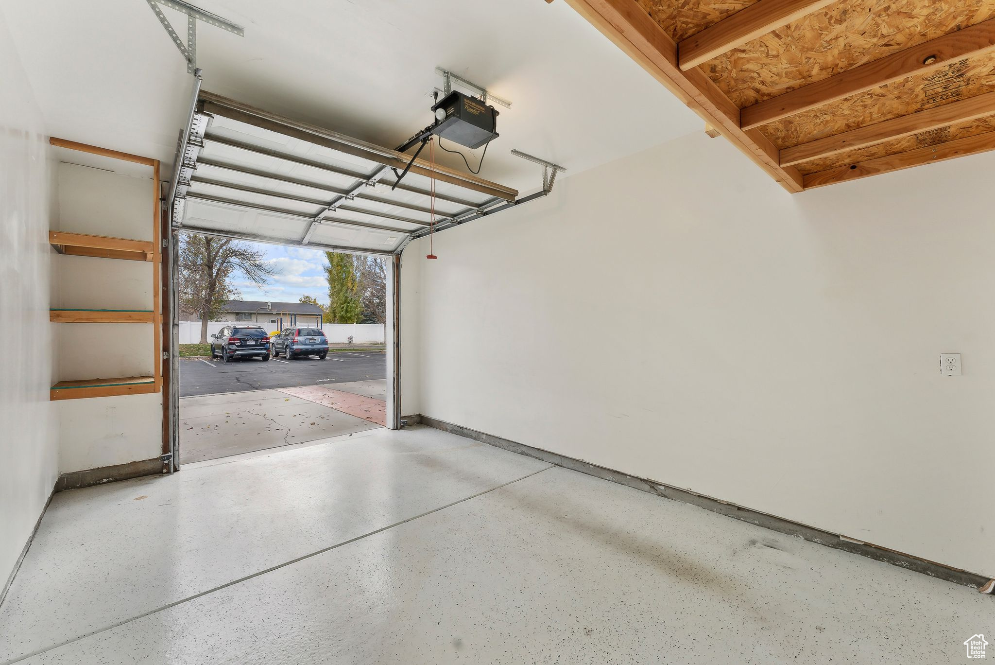 Garage featuring extra height, storage, and a garage door opener