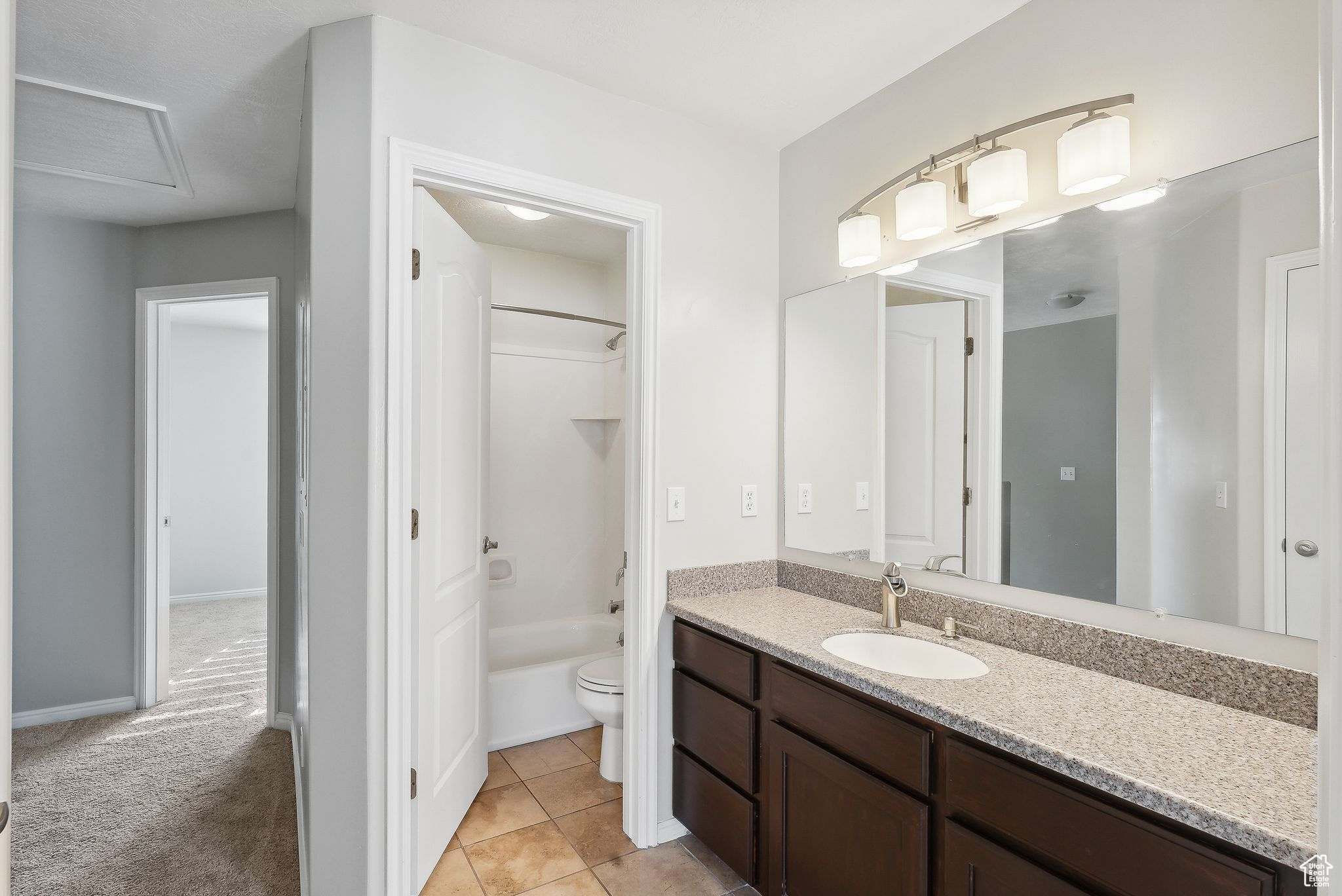 Full bathroom featuring tile patterned flooring, vanity, toilet, and shower / tub combination