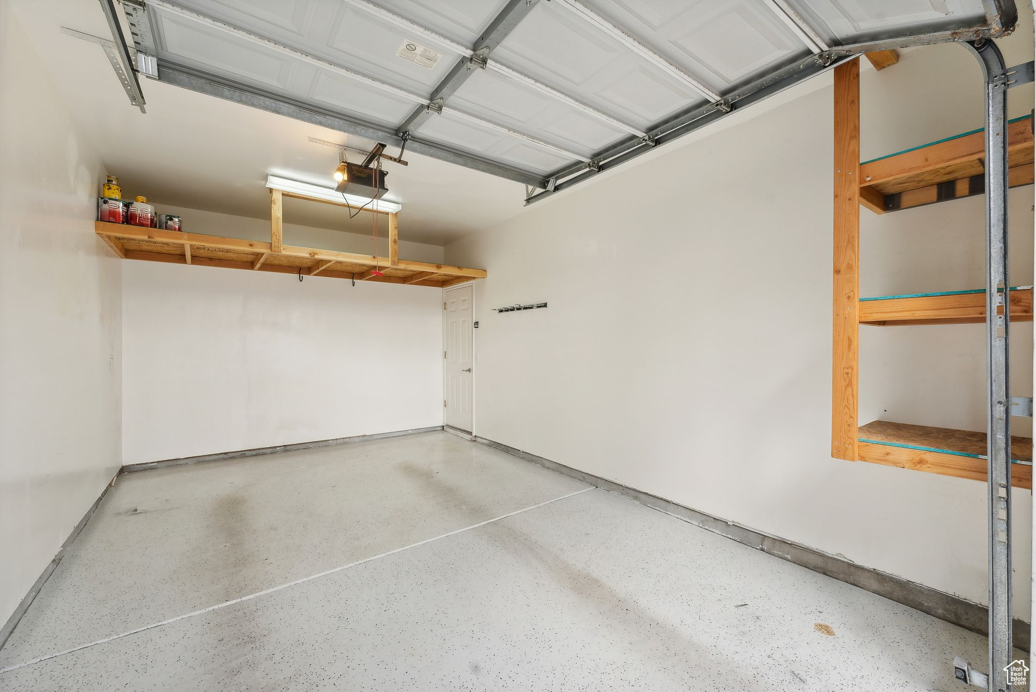 Garage featuring extra height, storage, and a garage door opener