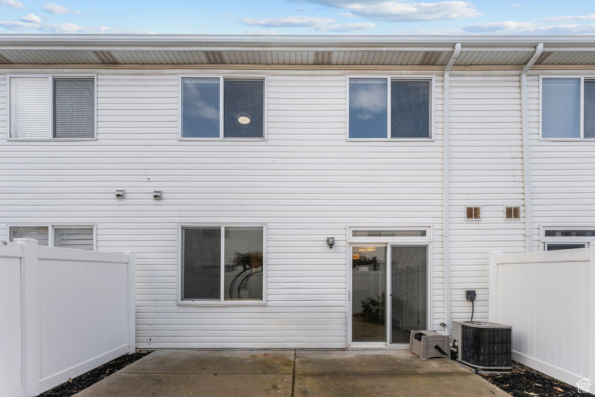 Back of house with a patio and central AC unit