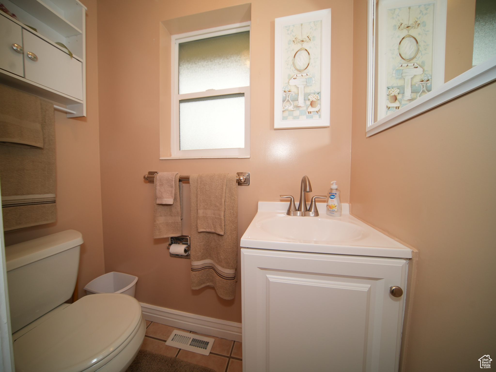 Bathroom featuring tile patterned flooring, vanity, and toilet