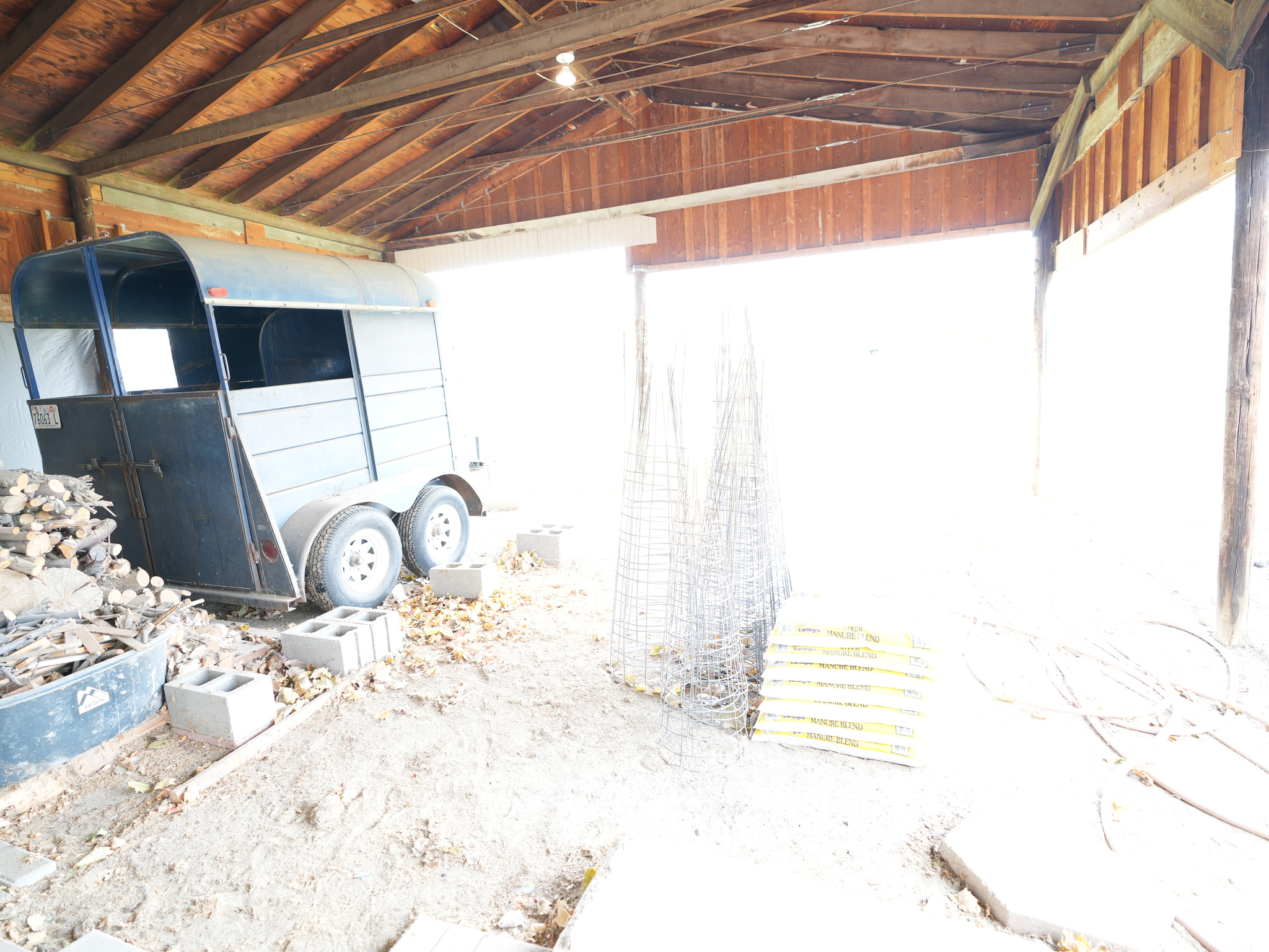 Covered storage area behind barn