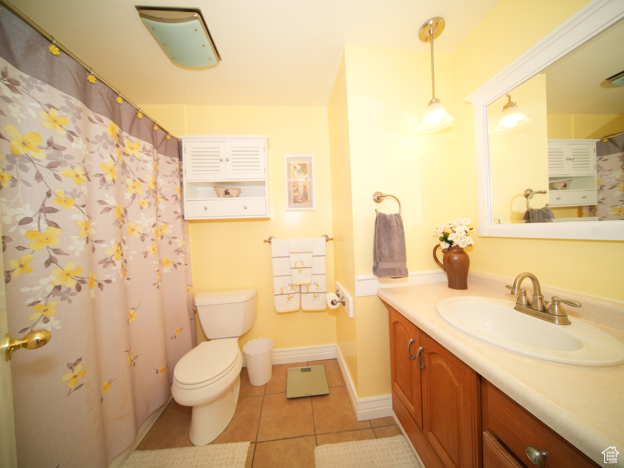 Bathroom featuring tile patterned flooring, vanity, and toilet