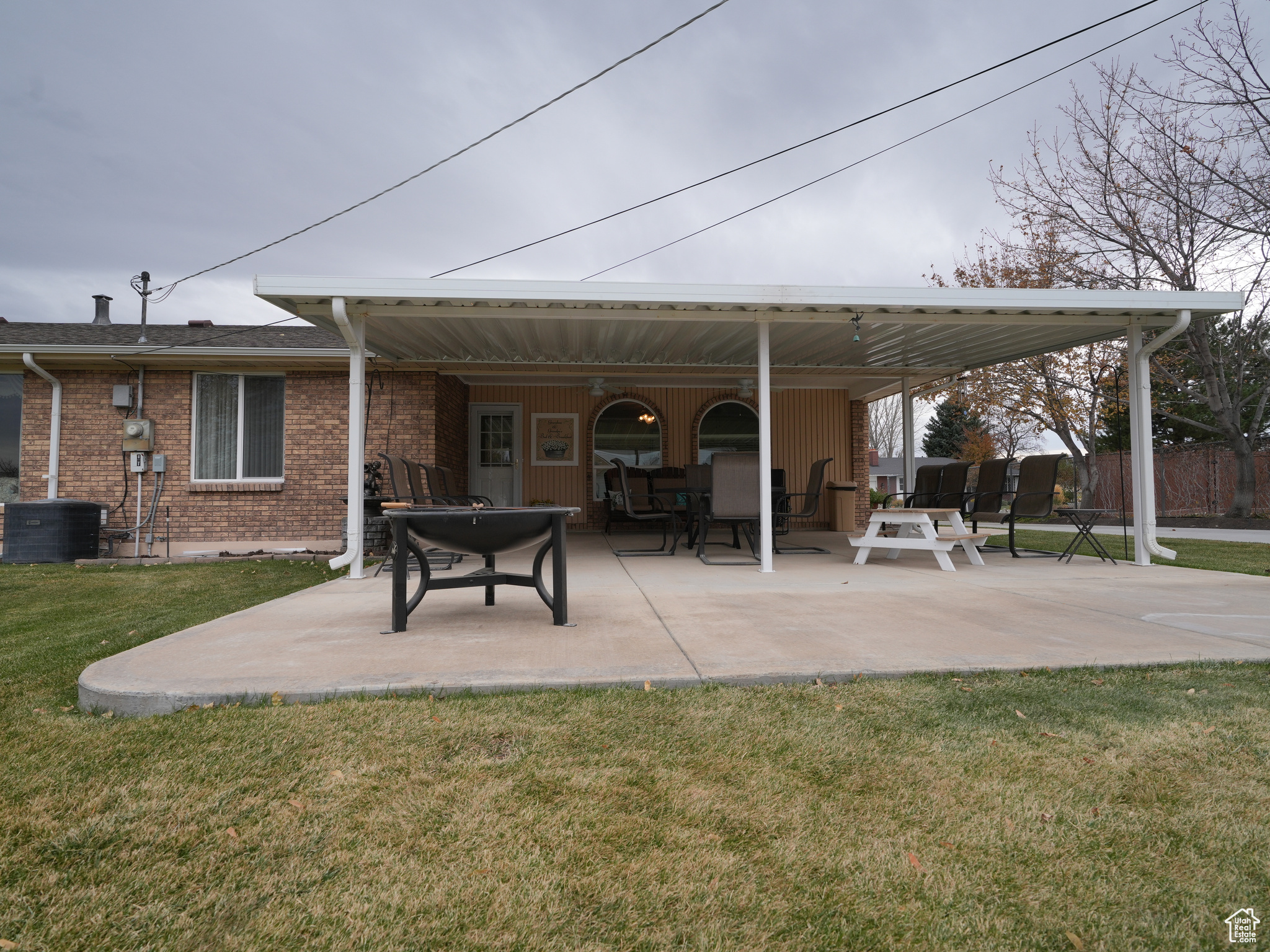 Back of house with a lawn and a patio area