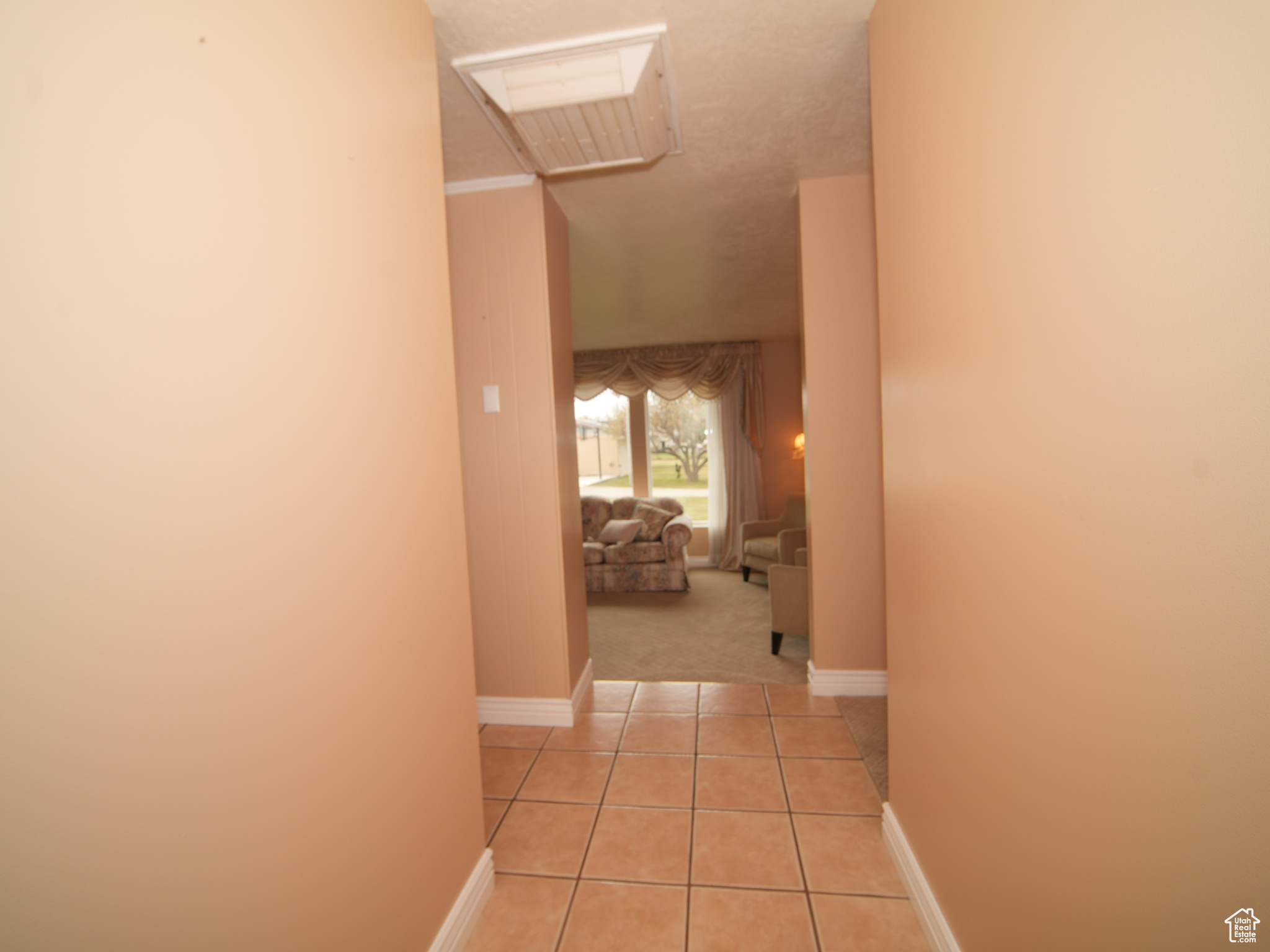 Corridor with light tile patterned flooring