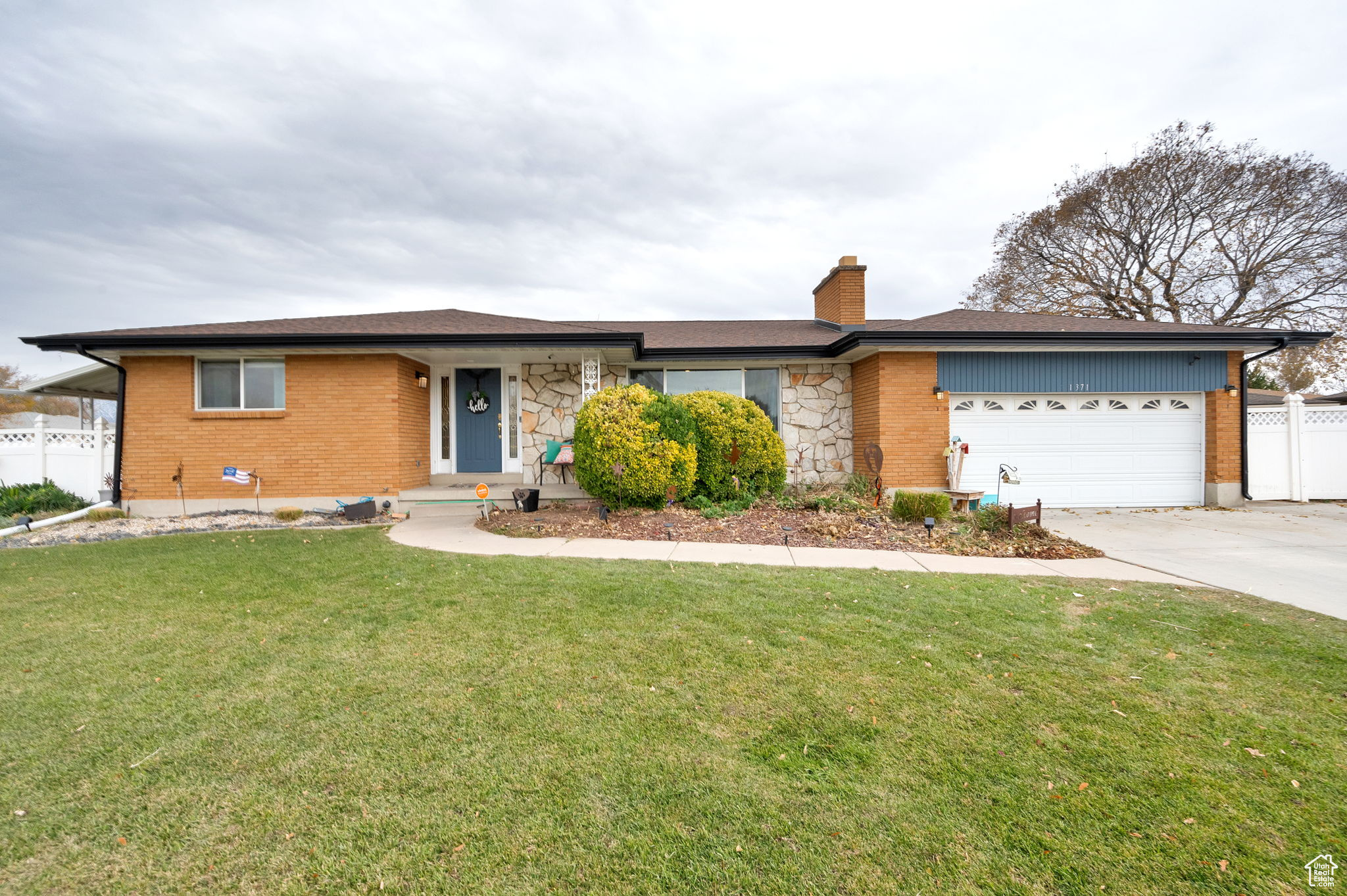 Ranch-style house with a front yard and a garage