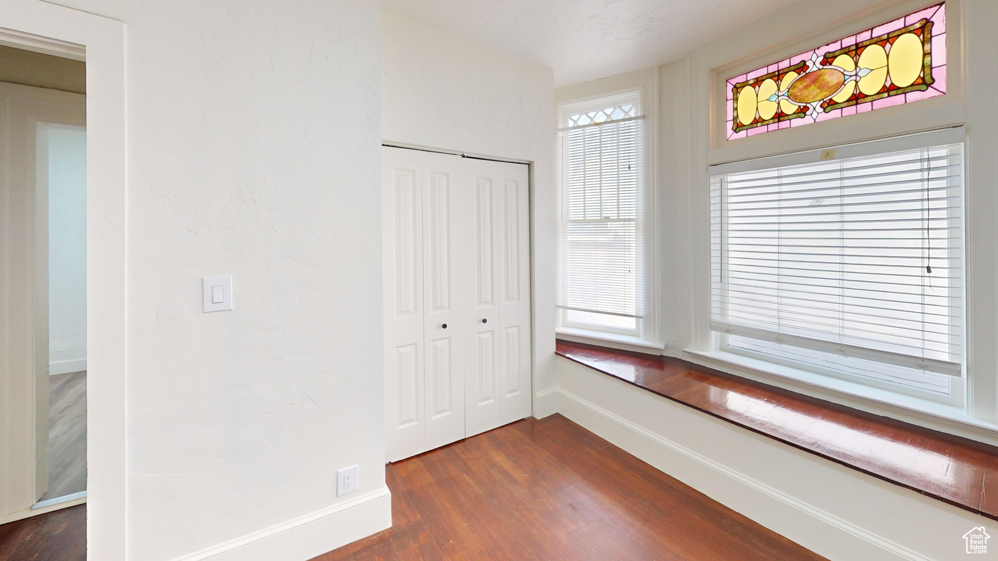 Corridor featuring dark wood-type flooring