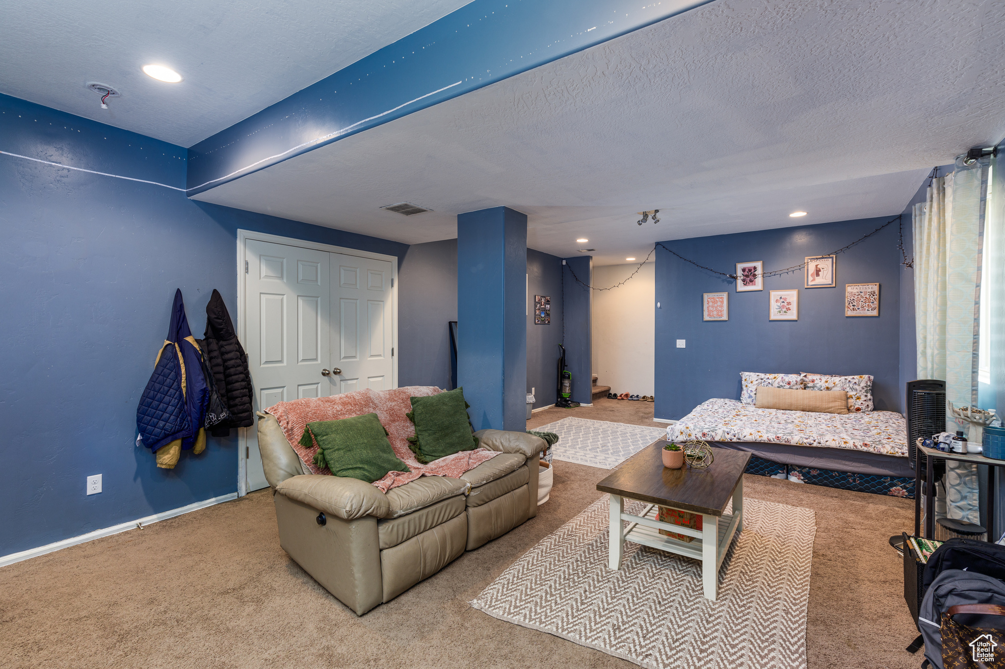 Carpeted living room featuring a textured ceiling