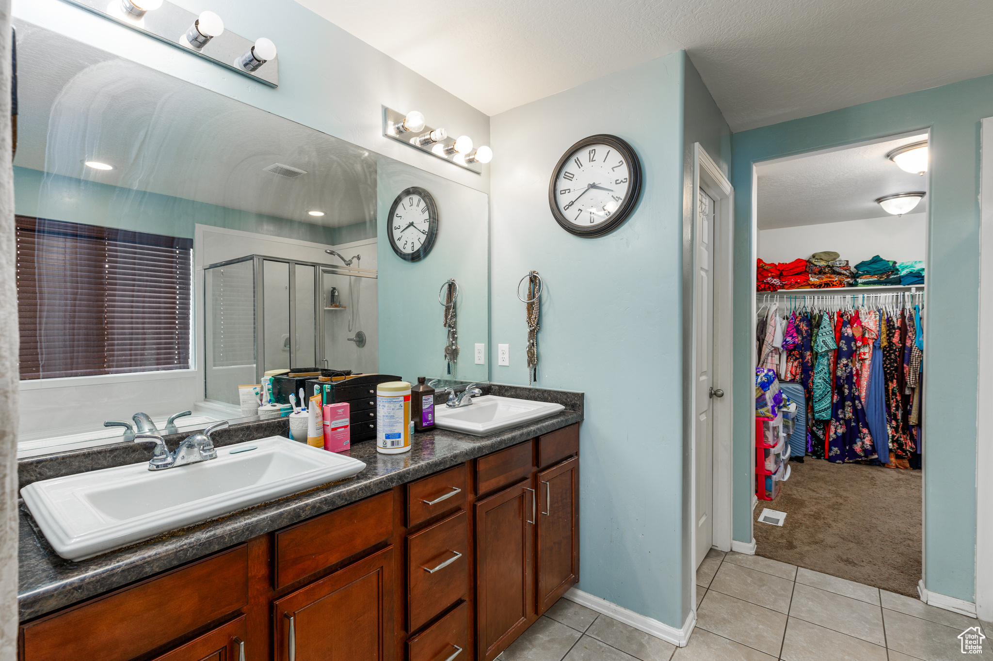 Bathroom with tile patterned flooring, vanity, and an enclosed shower