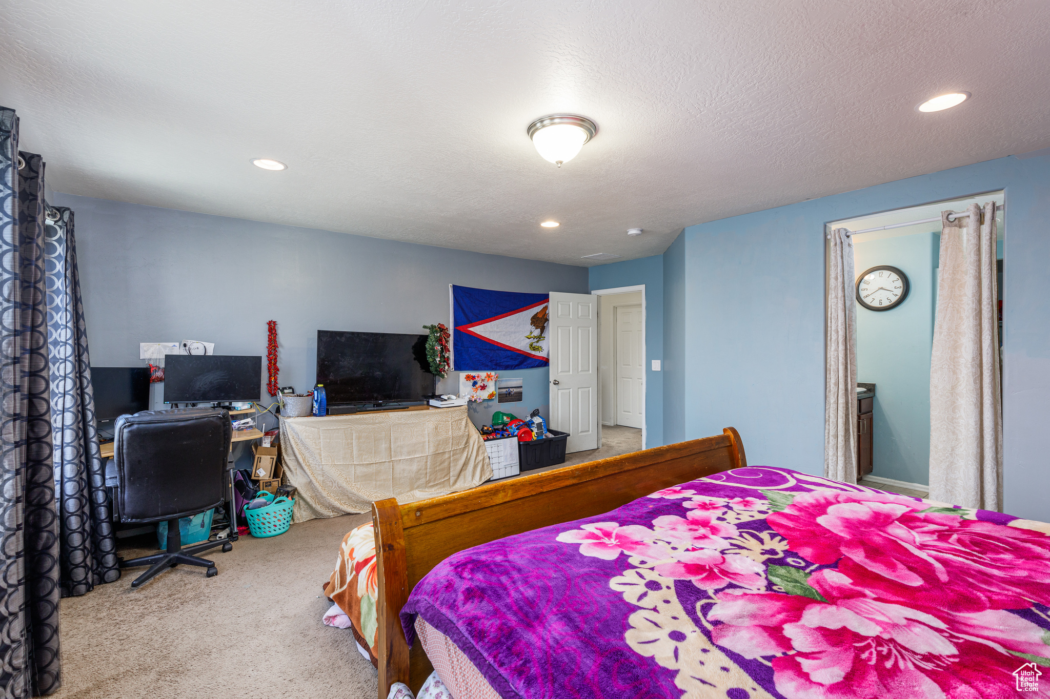 Carpeted bedroom with a textured ceiling