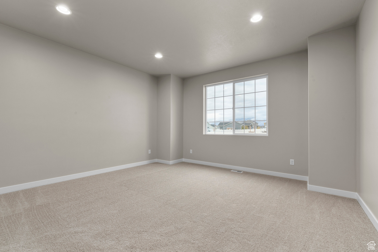 Spare room with light colored carpet