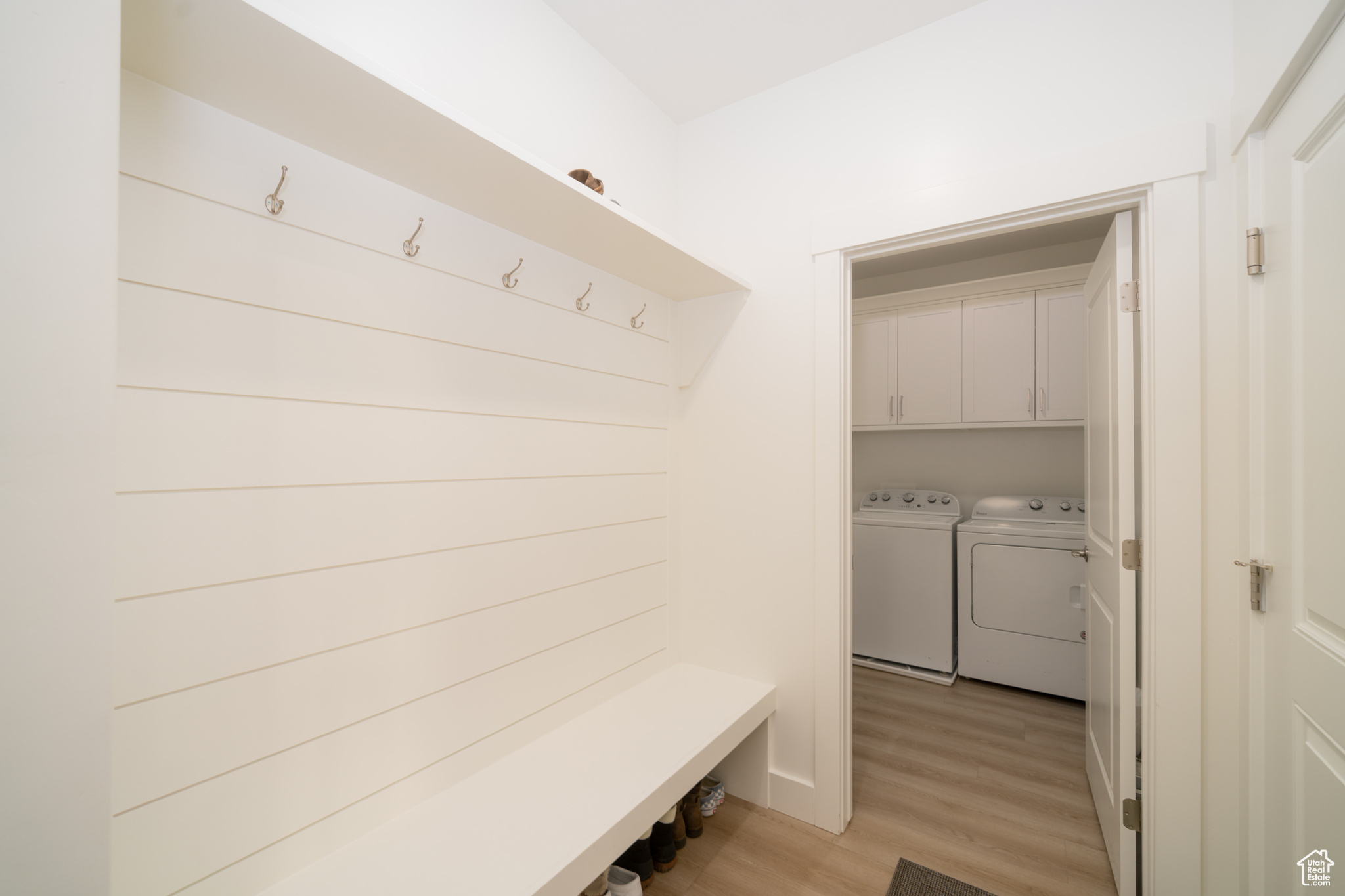 Mudroom with washer and dryer and light hardwood / wood-style flooring