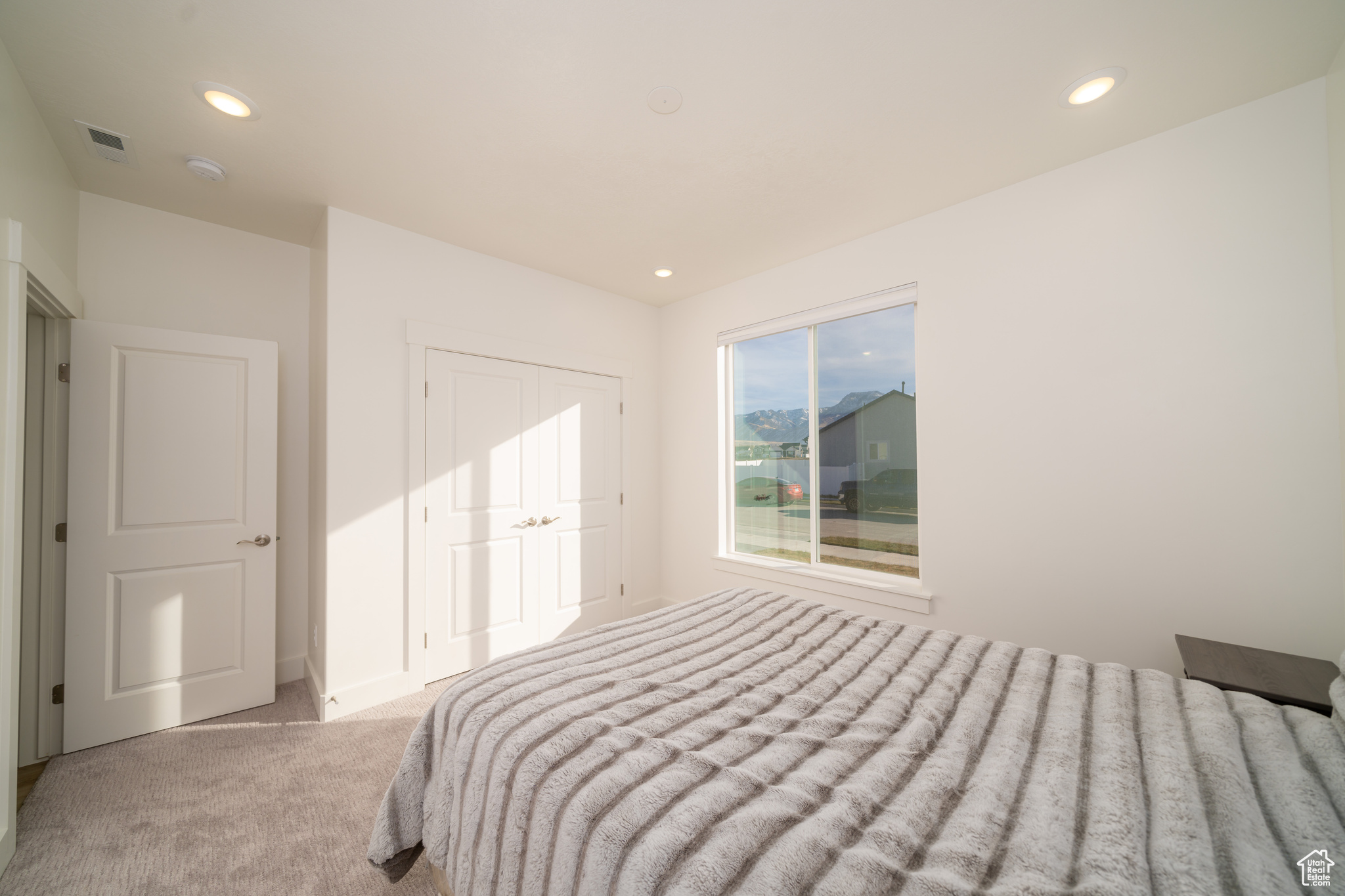 Bedroom with light carpet