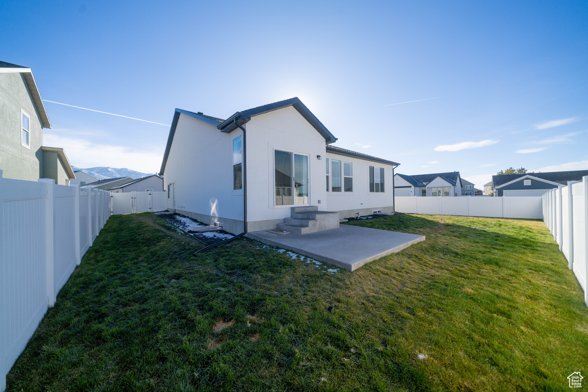 Back of property featuring a patio area and a yard