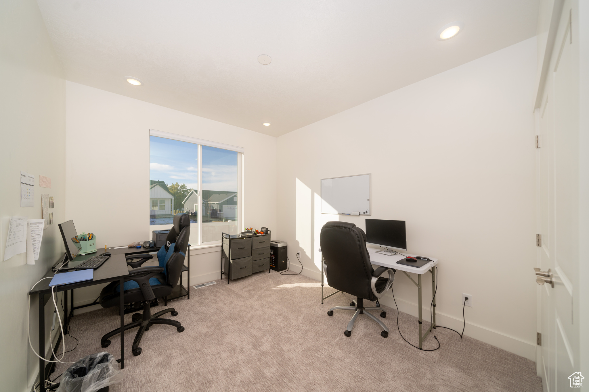 Office featuring light colored carpet