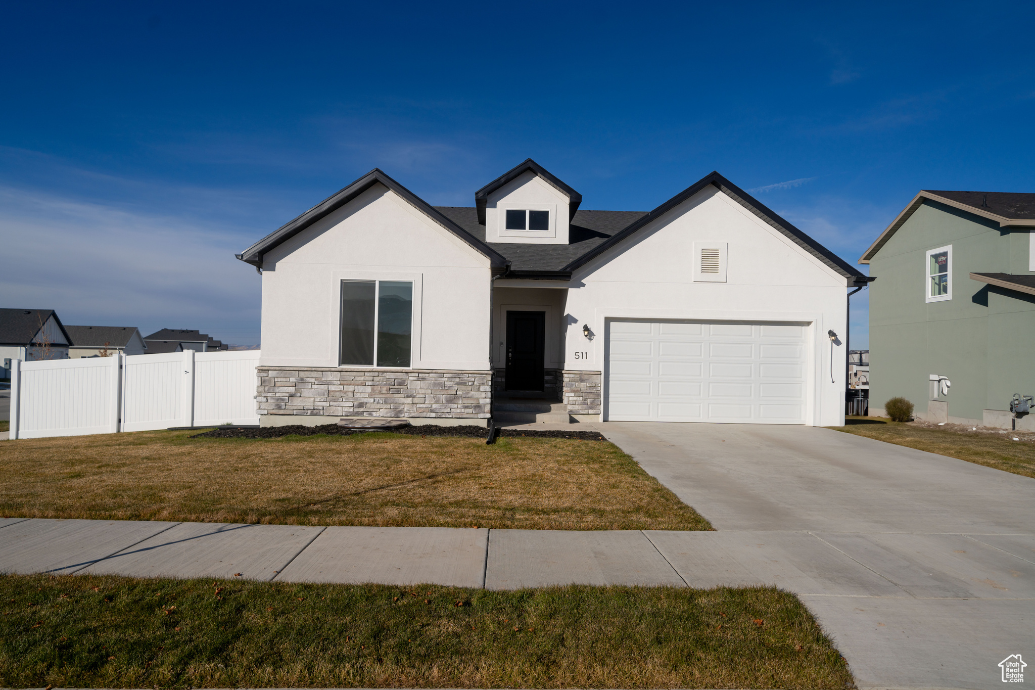 View of front of house with a front lawn and a garage