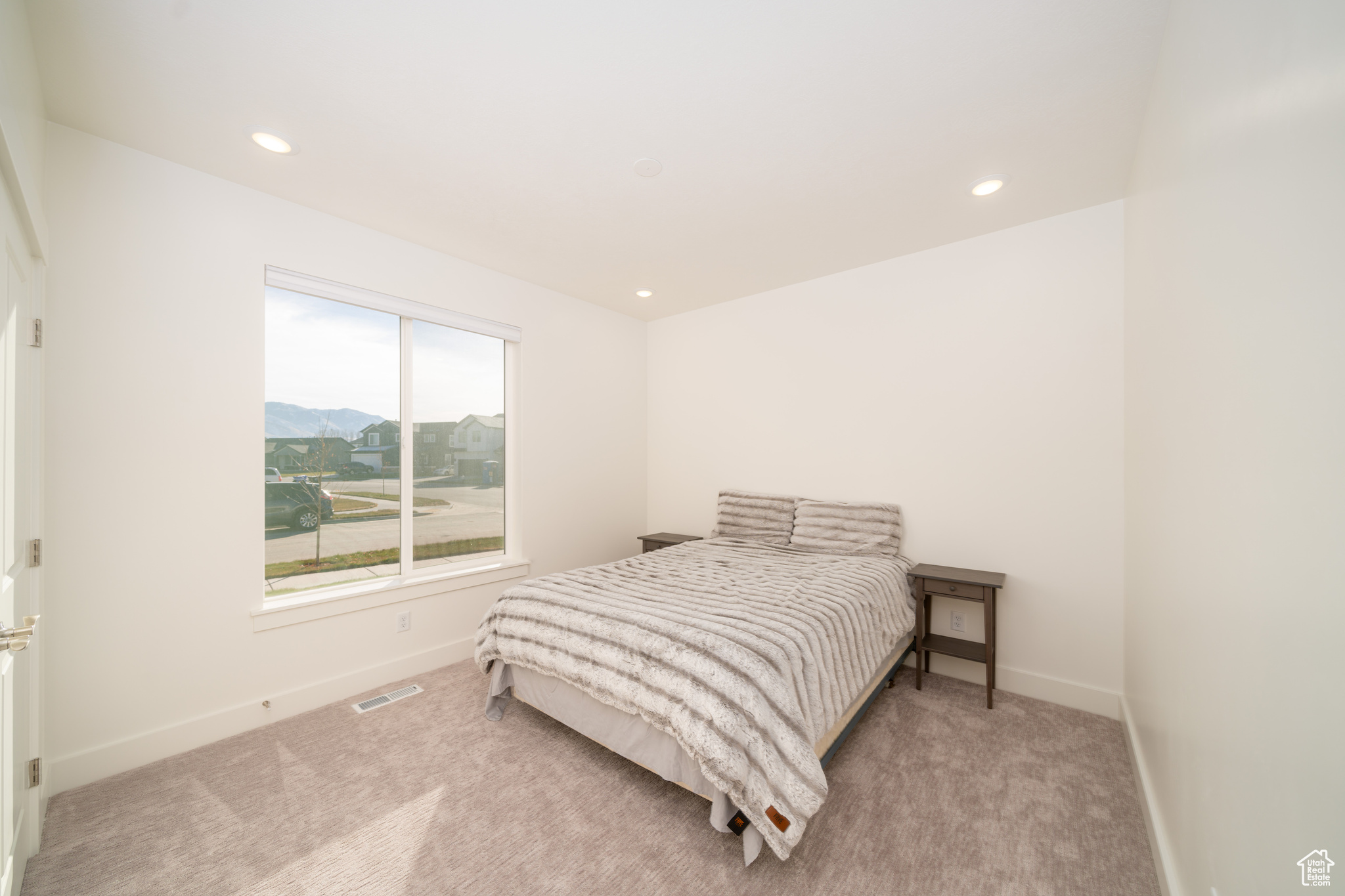 Carpeted bedroom with a mountain view