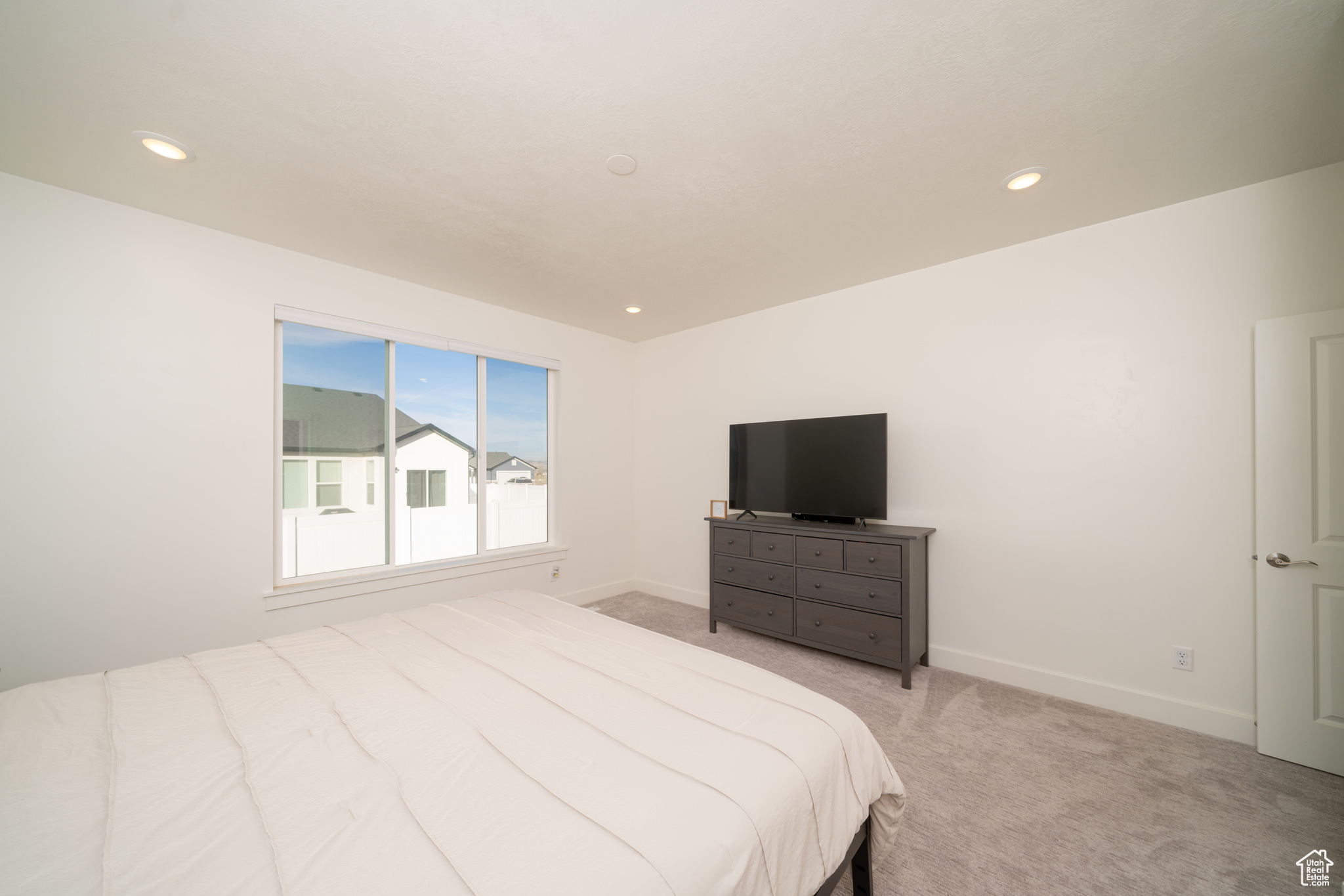 Bedroom featuring light colored carpet