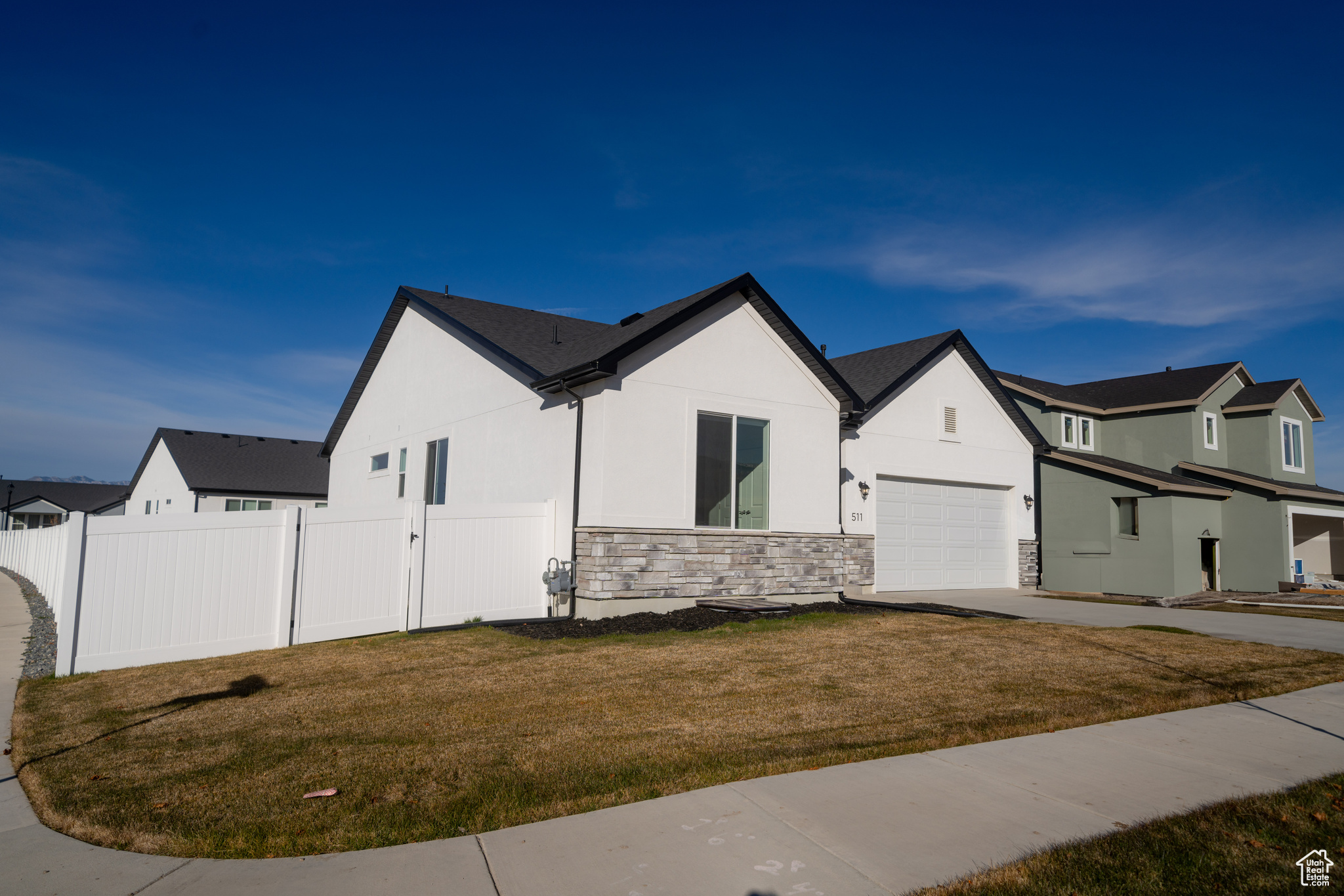 View of front of house featuring a front yard and a garage