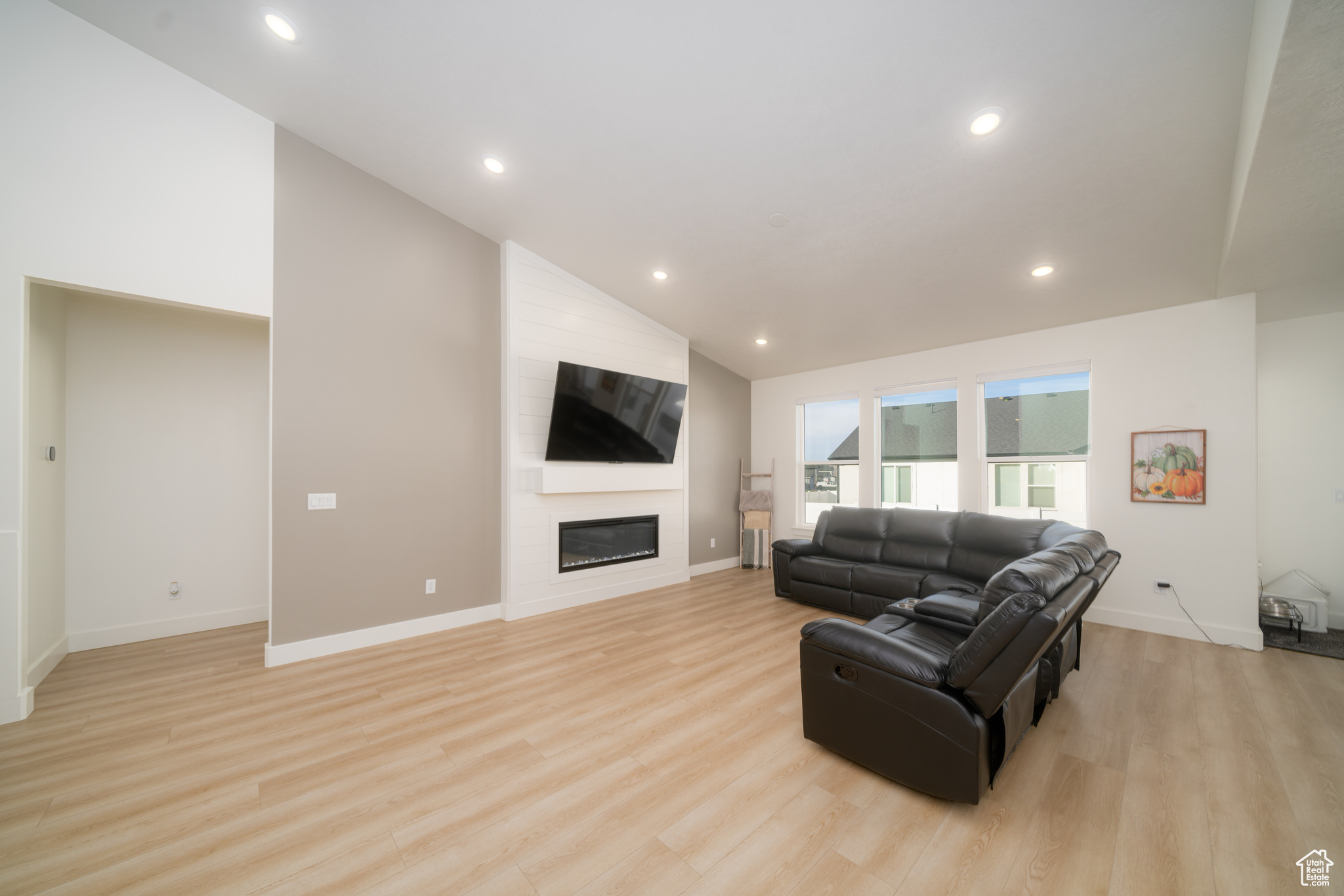 Living room featuring light hardwood / wood-style floors and high vaulted ceiling