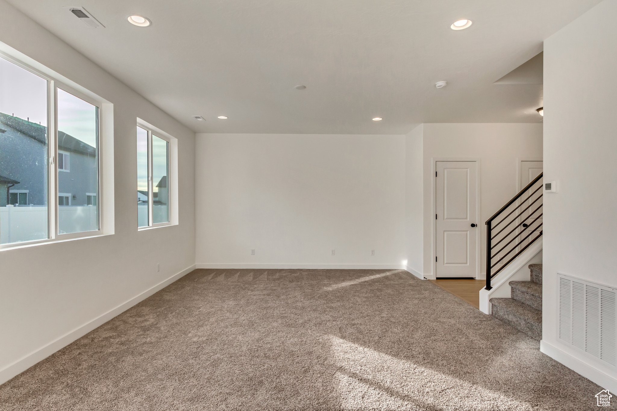 Unfurnished room with light carpet